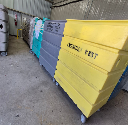Rows of colorful, wheeled bins labeled 