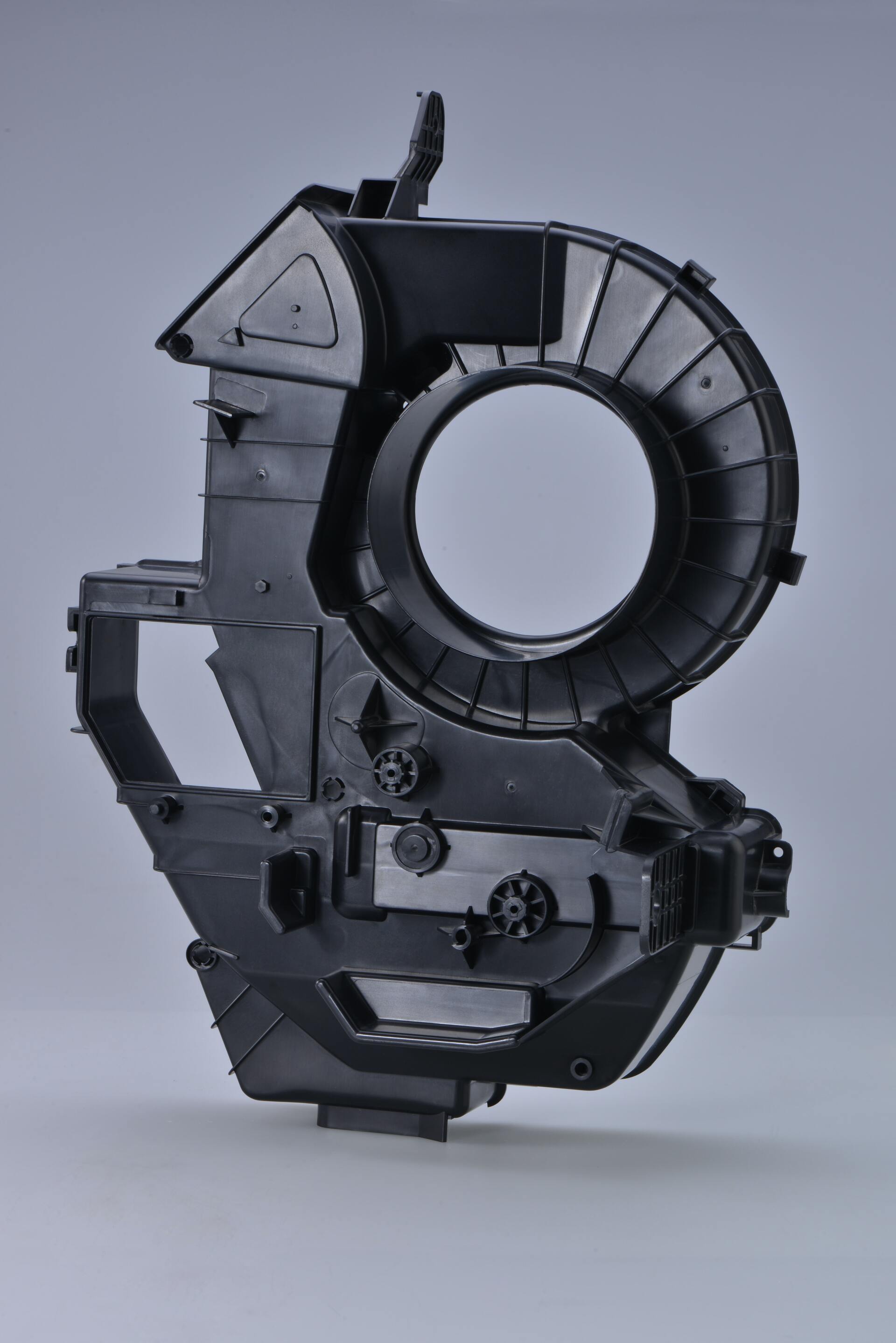 injection moulded black plastic component against a grey background