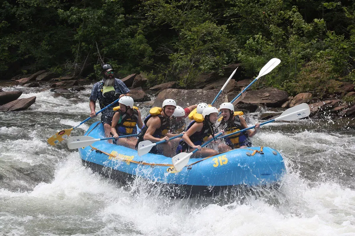 A group of people are rafting down Ocoee River. White Water Rafting.