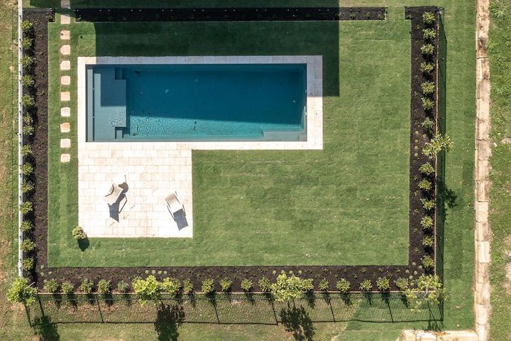 Drone shot of a pool and pool landscaping