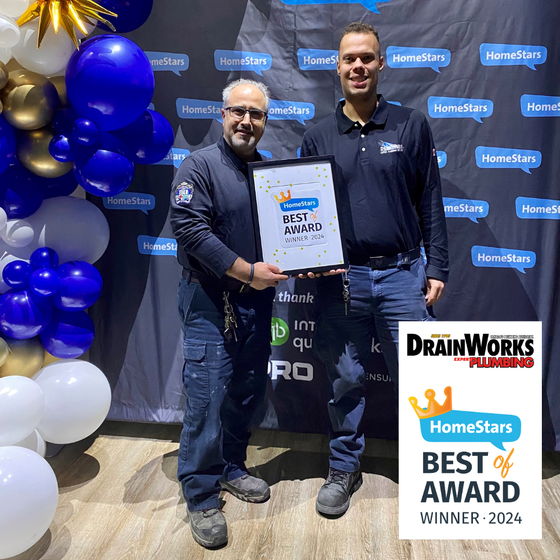 Two men are standing next to each other holding a framed certificate.