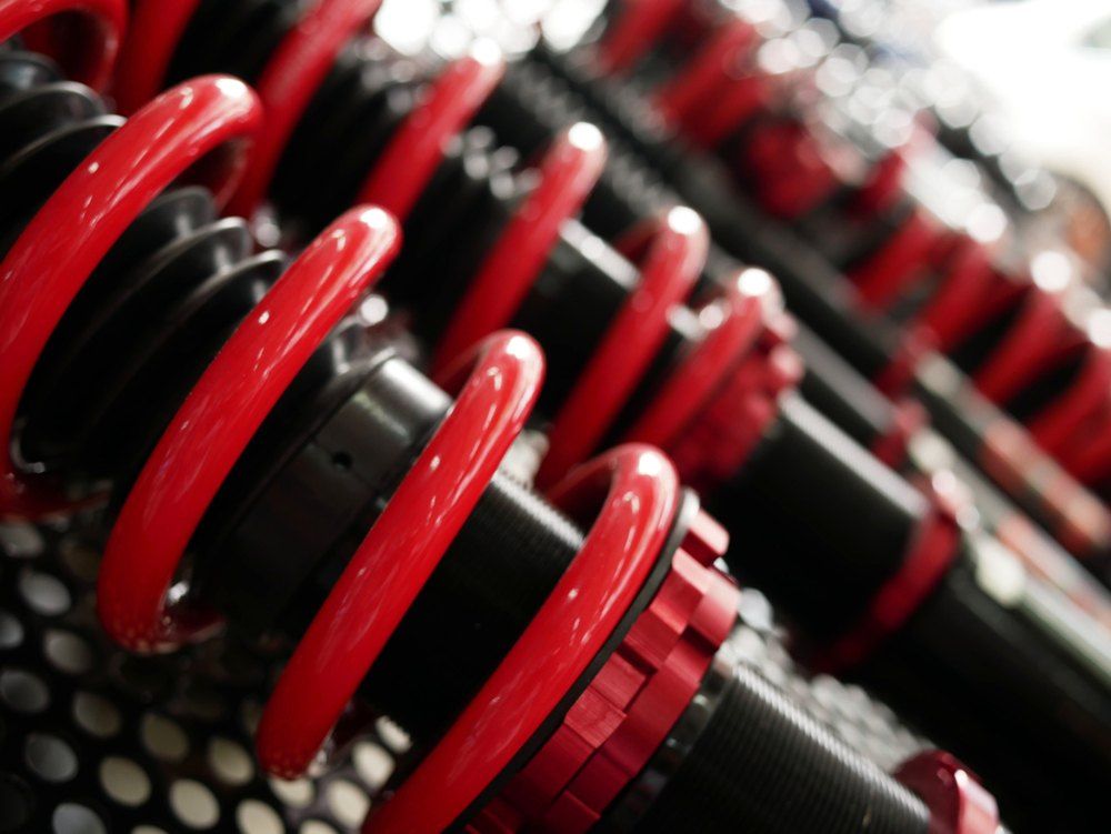 A Bunch of Red and Black Shock Absorbers Are Lined up In a Row — Modern Motors-Nabiac in Nabiac, NSW