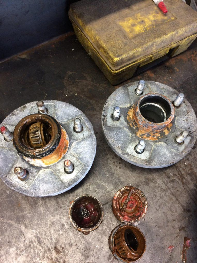 Two Wheel Hubs Are Sitting on A Table Next to A Toolbox — Modern Motors-Nabiac in Nabiac, NSW
