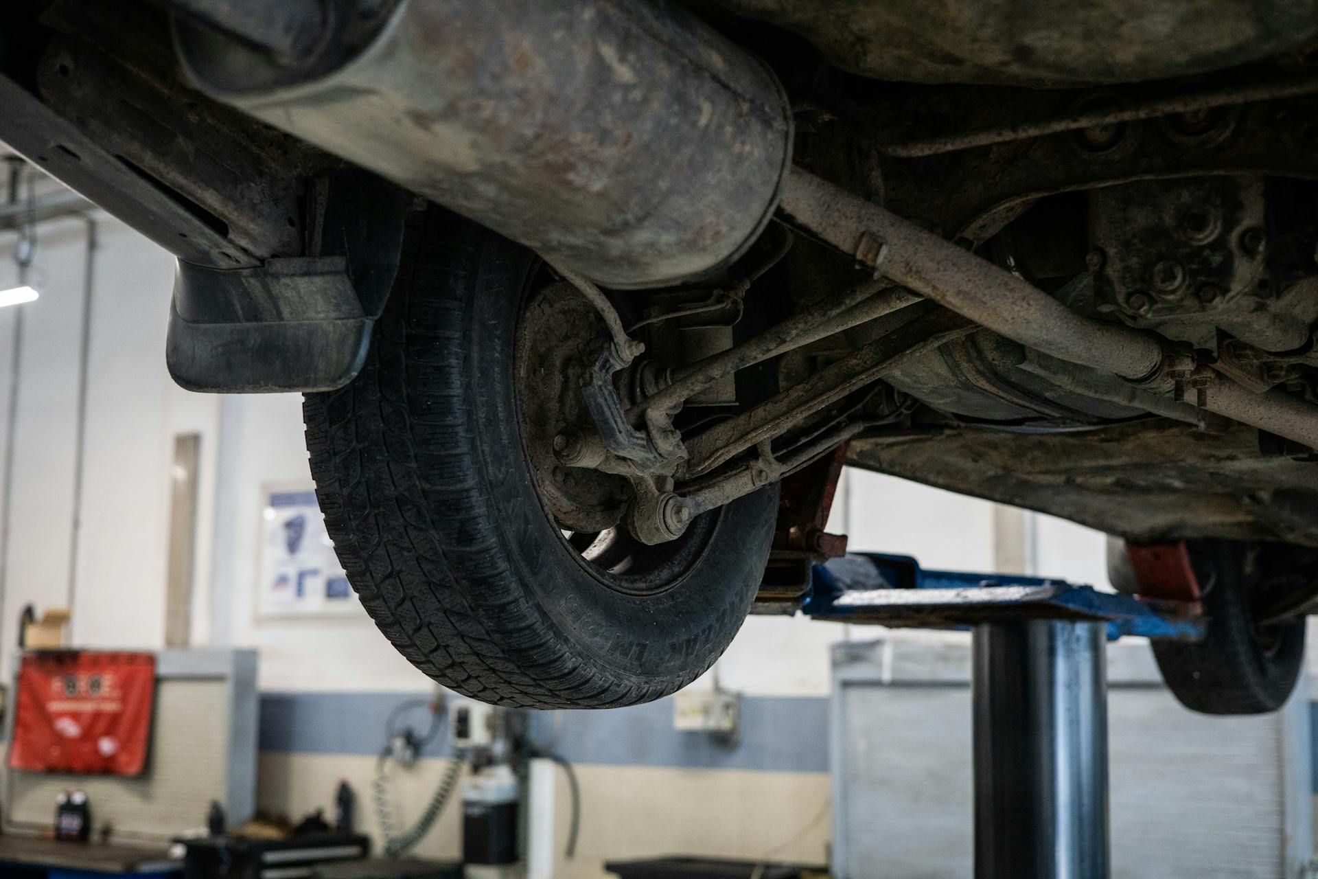 A Dump Truck Is Sitting on A Lift in A Garage — Modern Motors-Nabiac in Nabiac, NSW