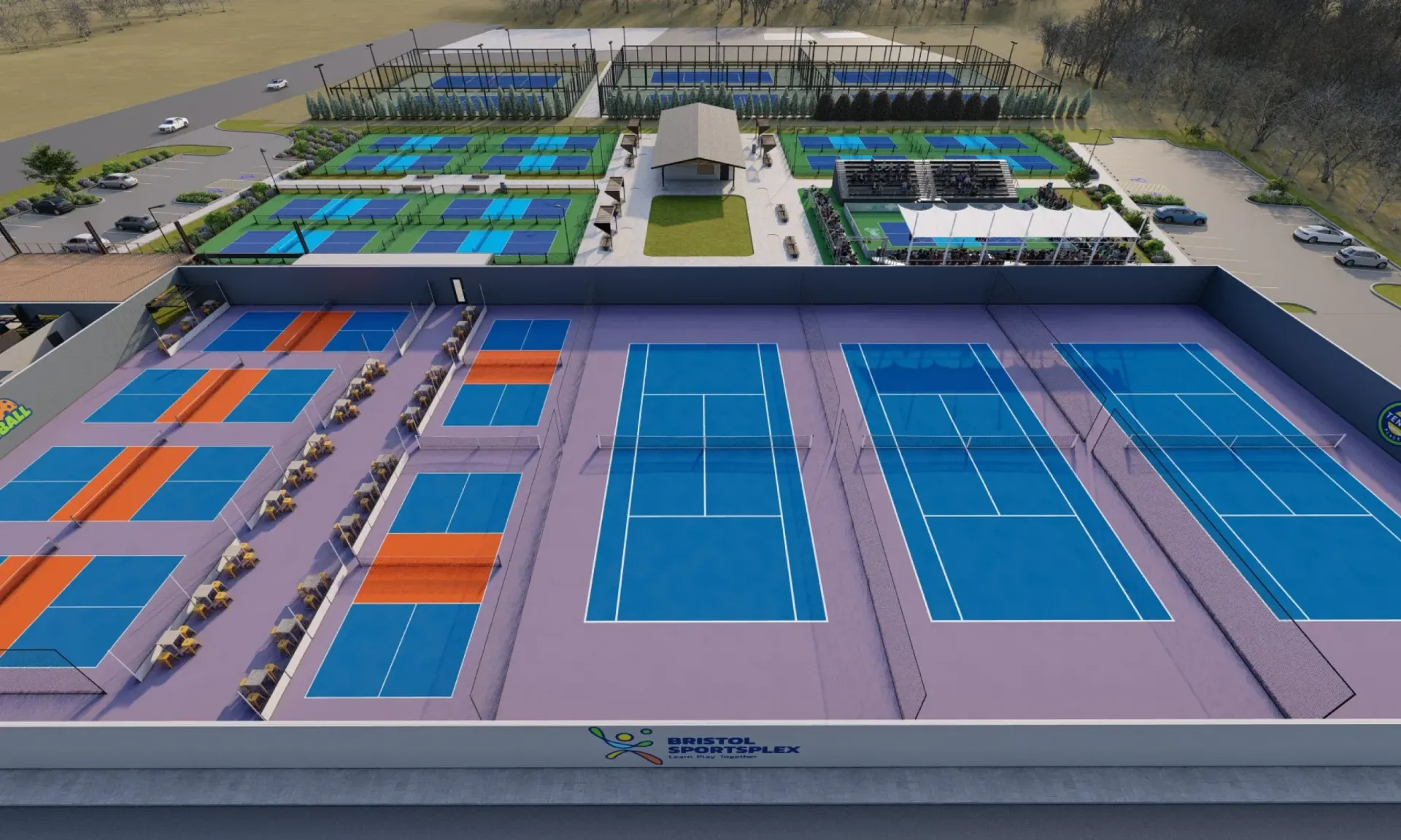 Aerial view of outdoor pickleball courts in blue, green, and orange, surrounded by a facility.