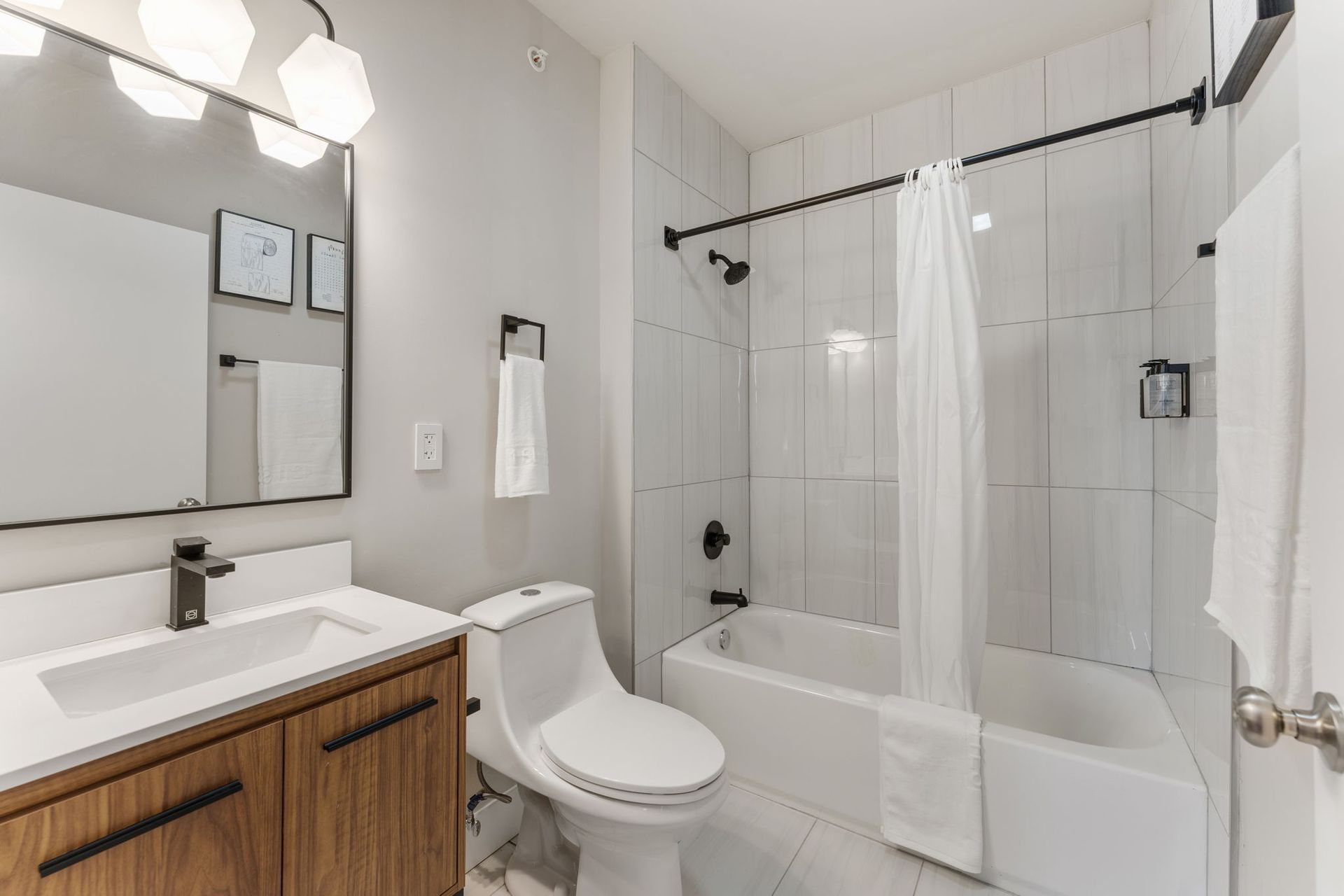 A bathroom with a toilet , sink , and bathtub.