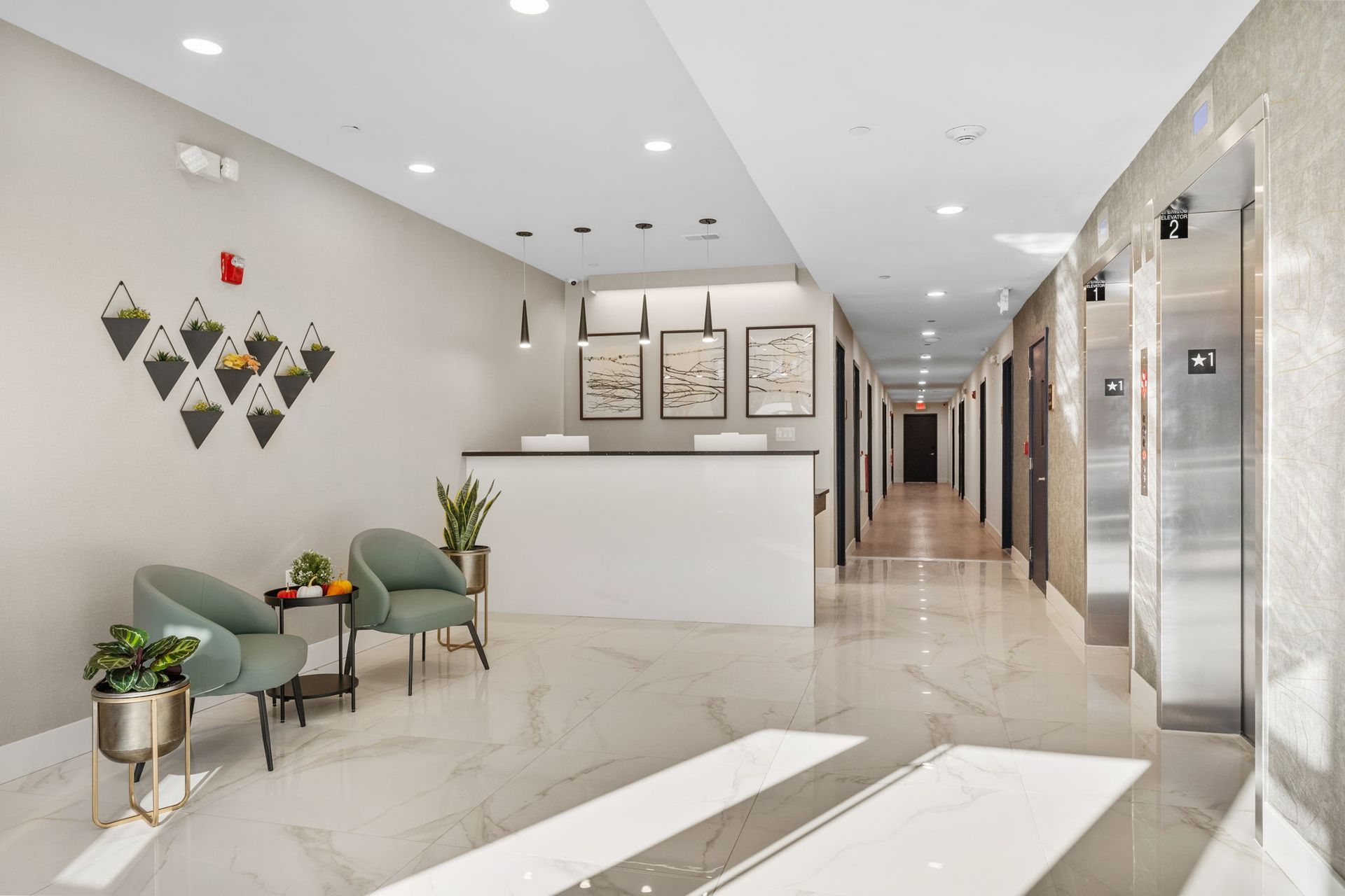 A lobby with a reception desk and chairs in a building.