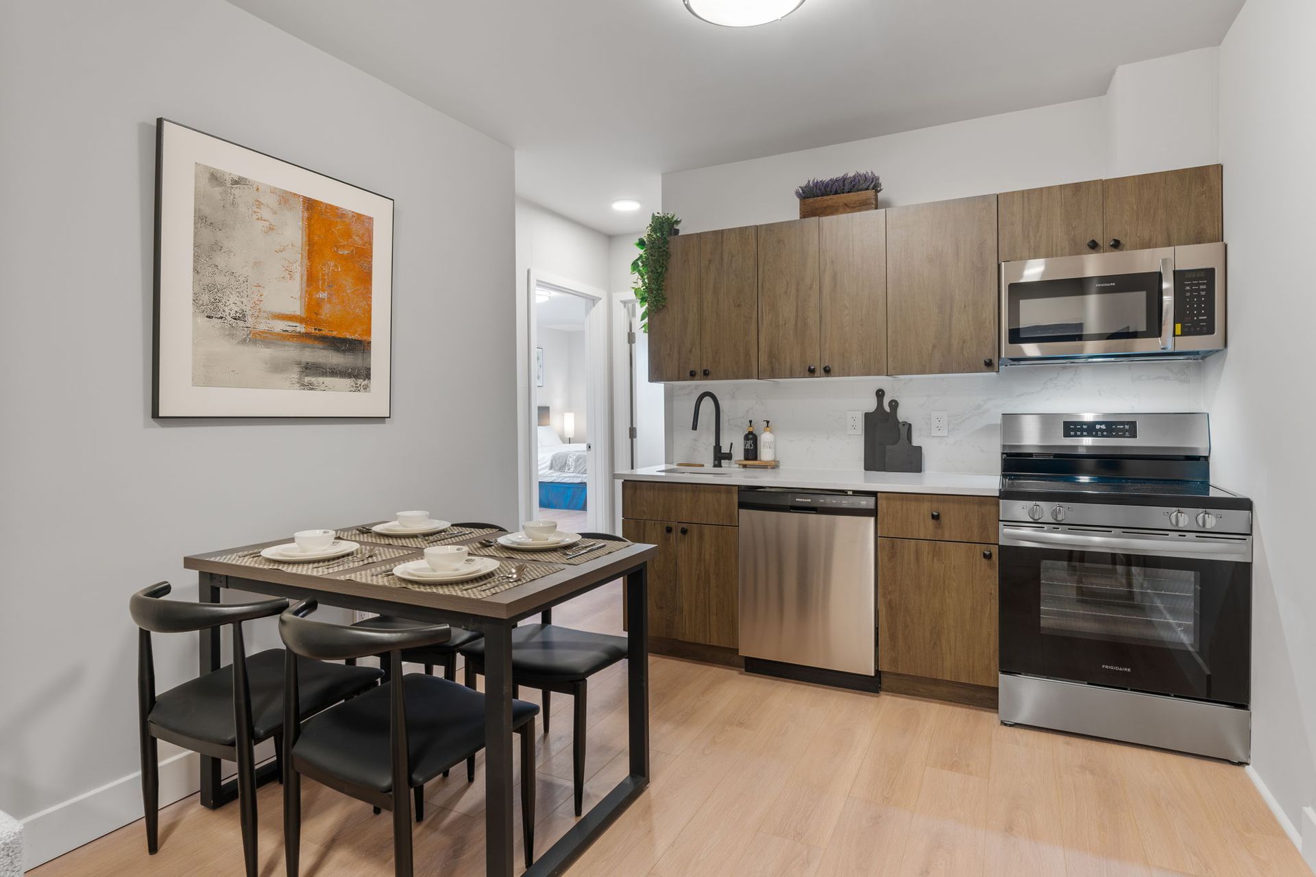 A kitchen with stainless steel appliances and wooden cabinets