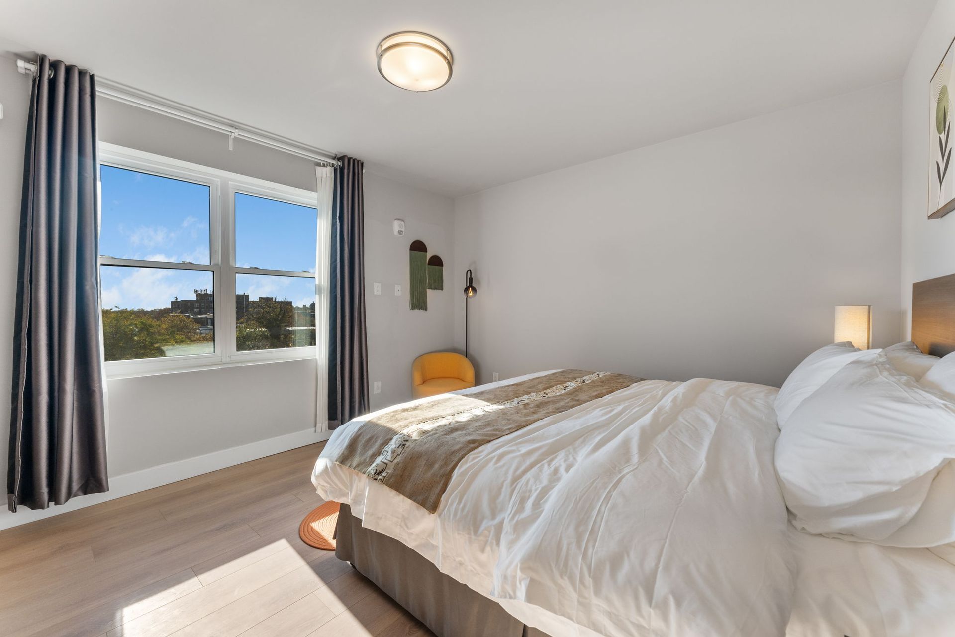 A bedroom with a large bed and a large window