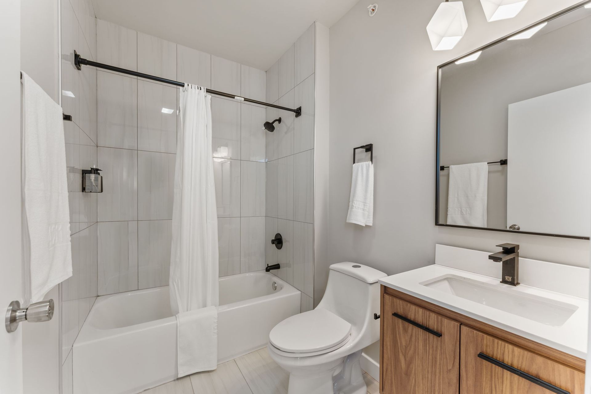 A bathroom with a toilet , sink , tub and shower.