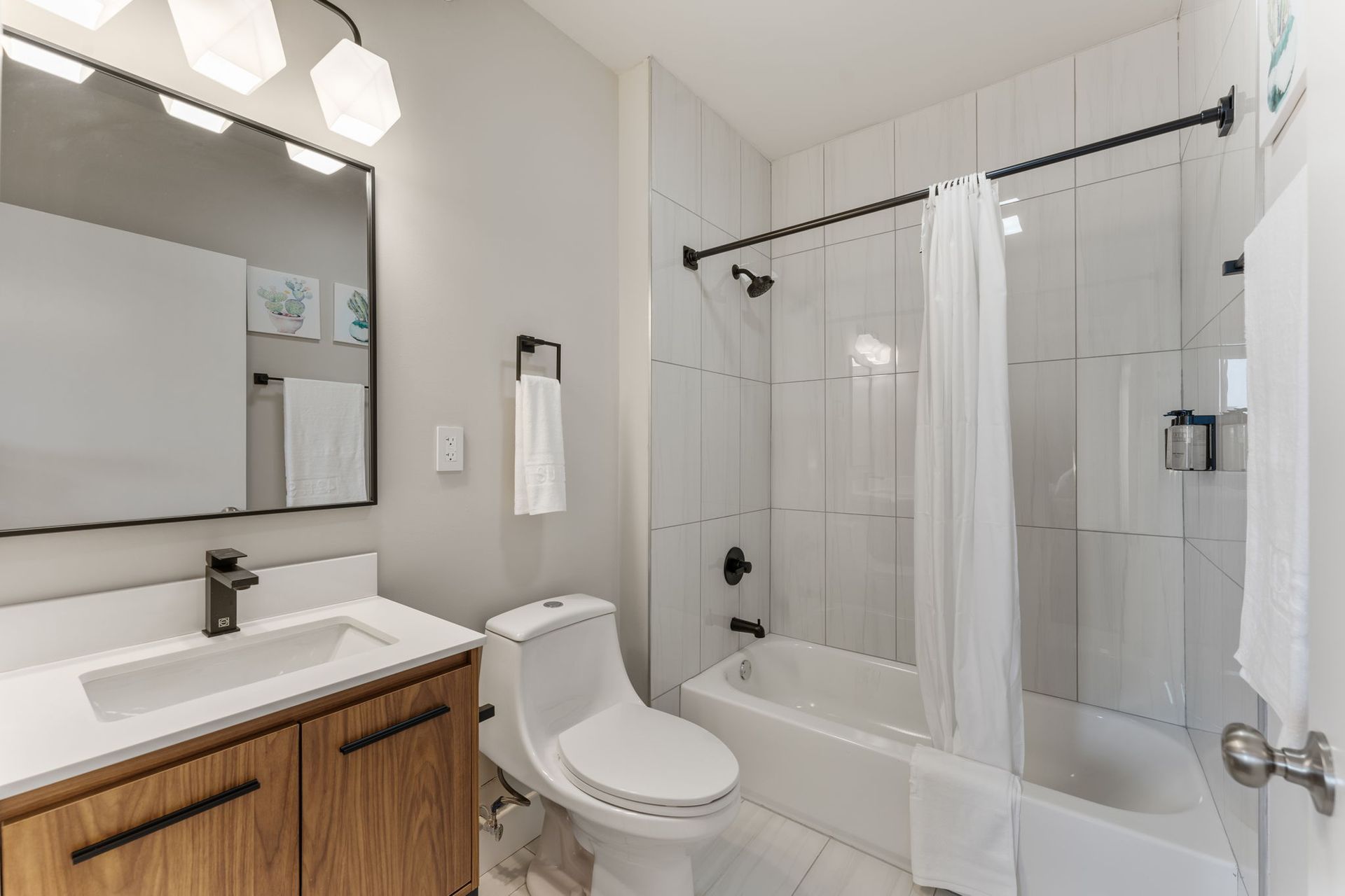 A bathroom with a toilet , sink , and bathtub.