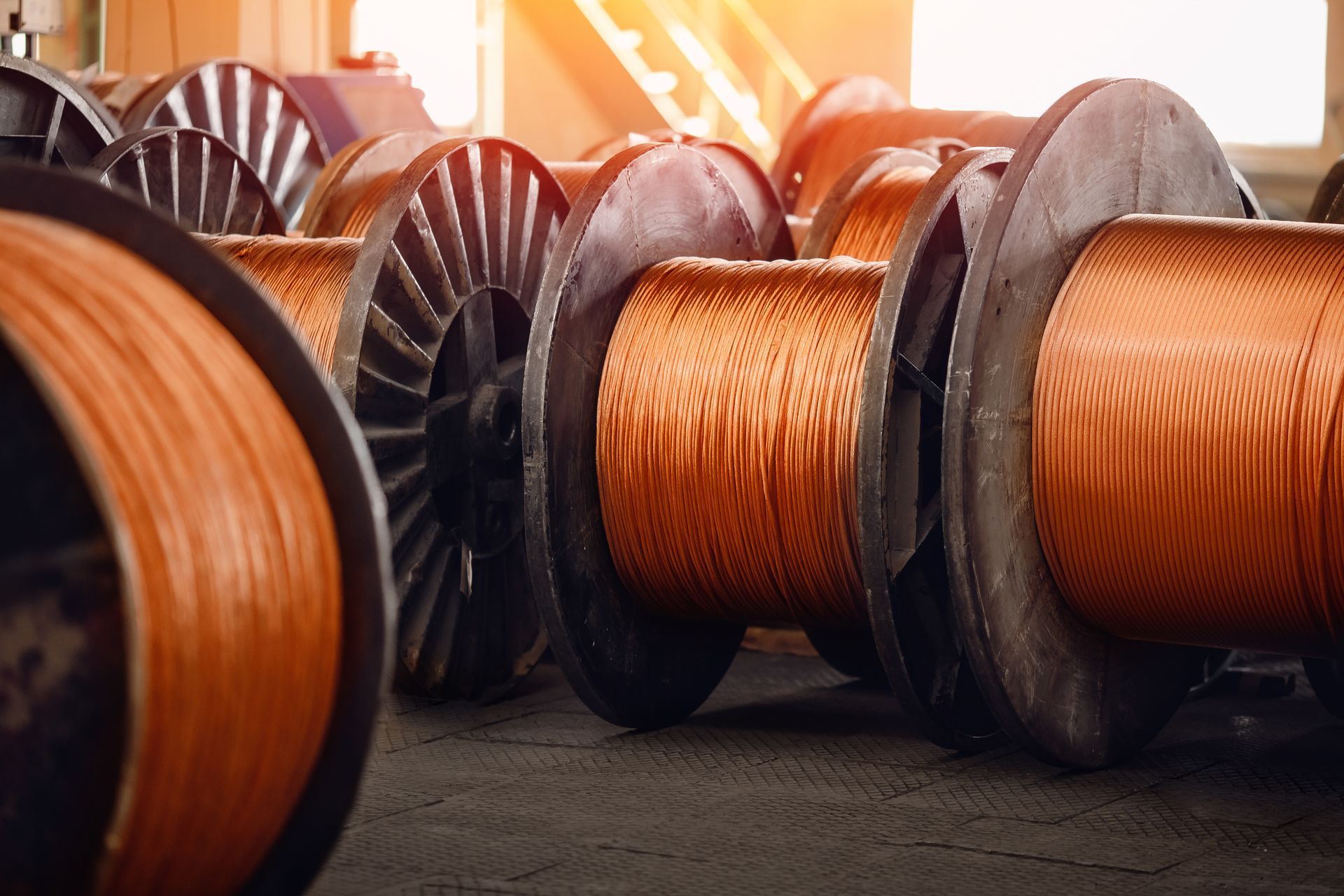 Large reels of heavy-duty wiring used in industrial scrap copper wire recycling and metal recovery