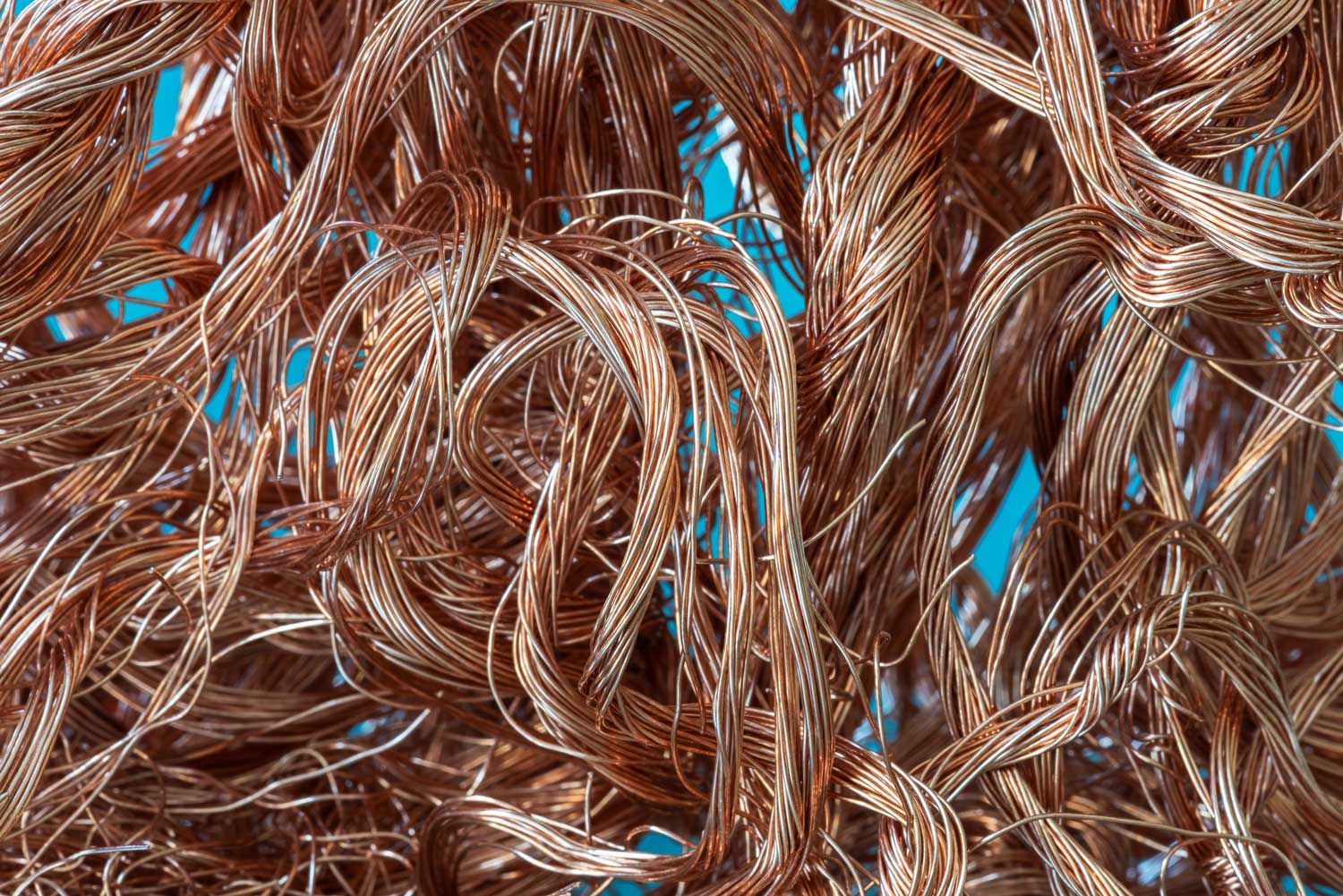 Tangled copper wires in a pile, visible strands of reddish-brown metal.