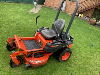 Orange Lawn Mower on Lawn Outside of House — Michael Flick Horticulture in Coffs Harbour, NSW