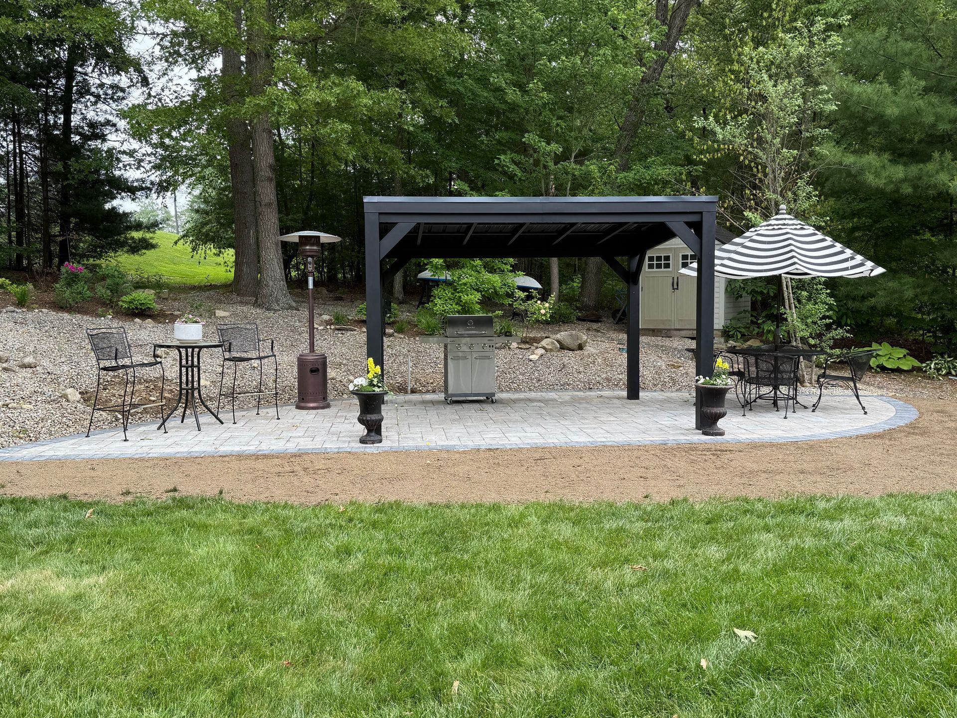 There is a fire pit in the backyard of a house.