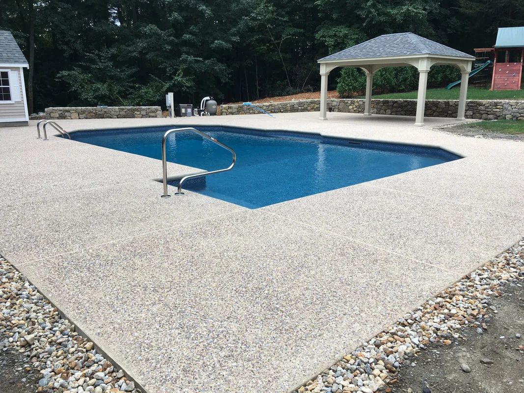 A large swimming pool with a gazebo in the background.