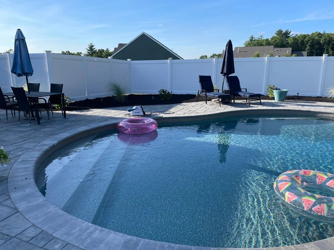 A large swimming pool with a pink flamingo float in it.