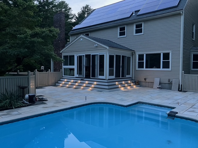 A large house with a swimming pool in front of it