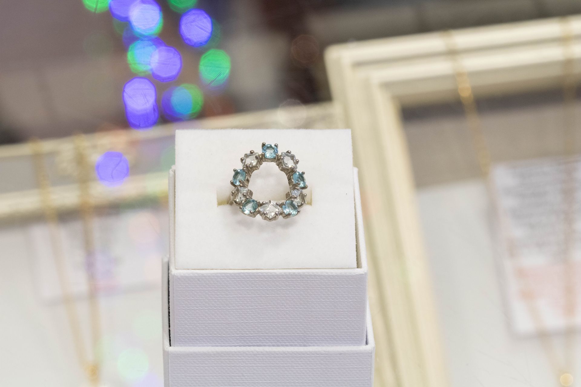 Arlington Jewellery - Crystal floral ring on white display stand in a jewelry store window