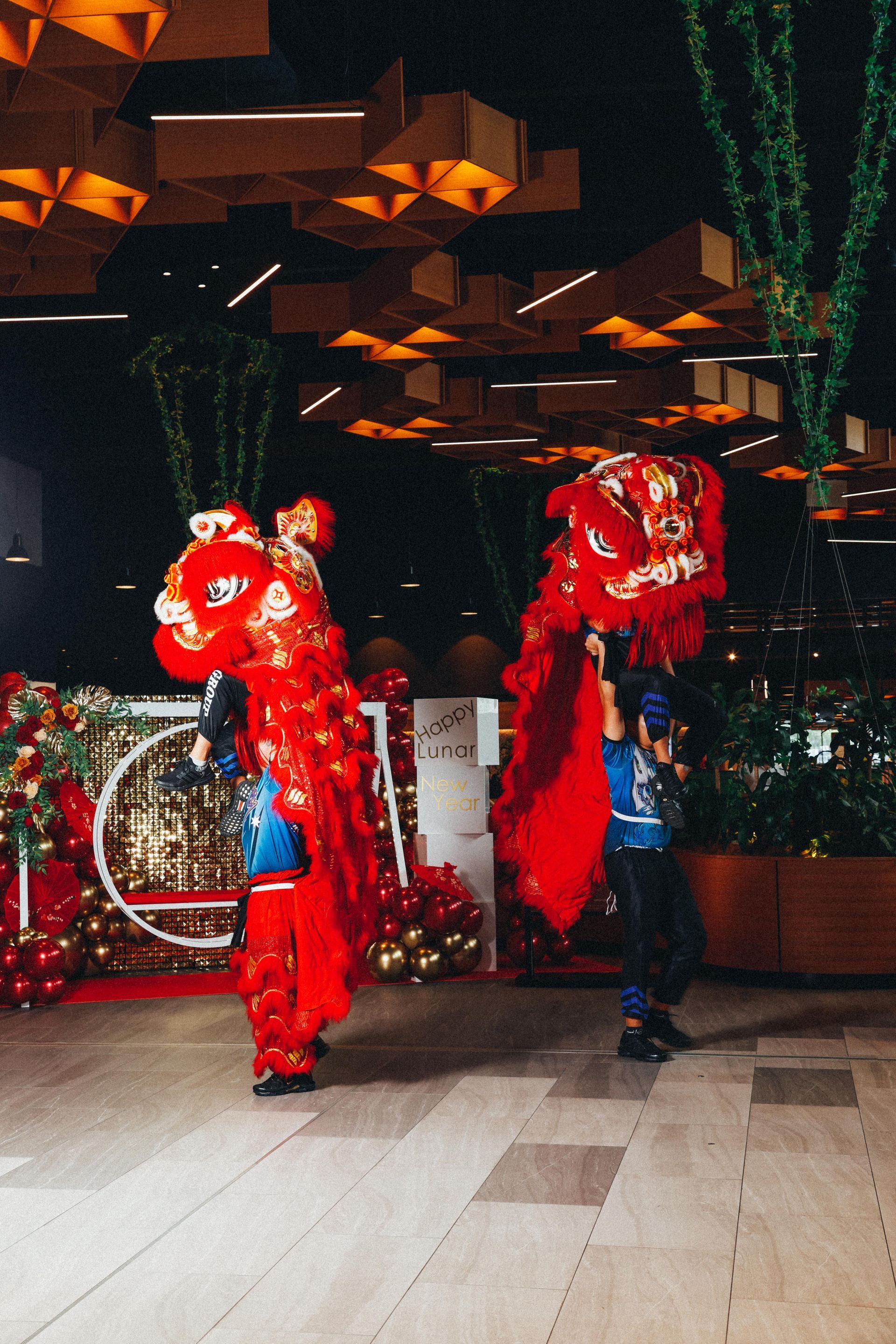 A couple of people in red costumes are dancing in a room.