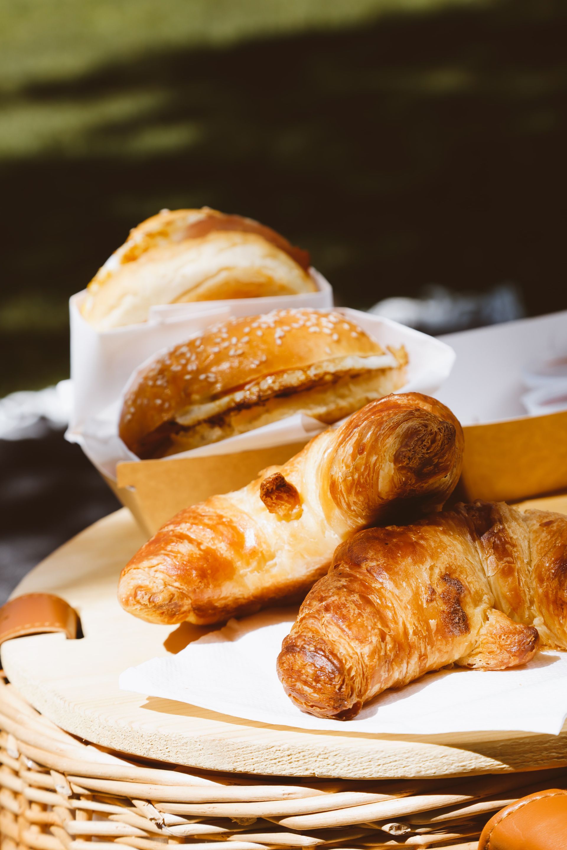 A basket filled with croissants and pastries on a table.