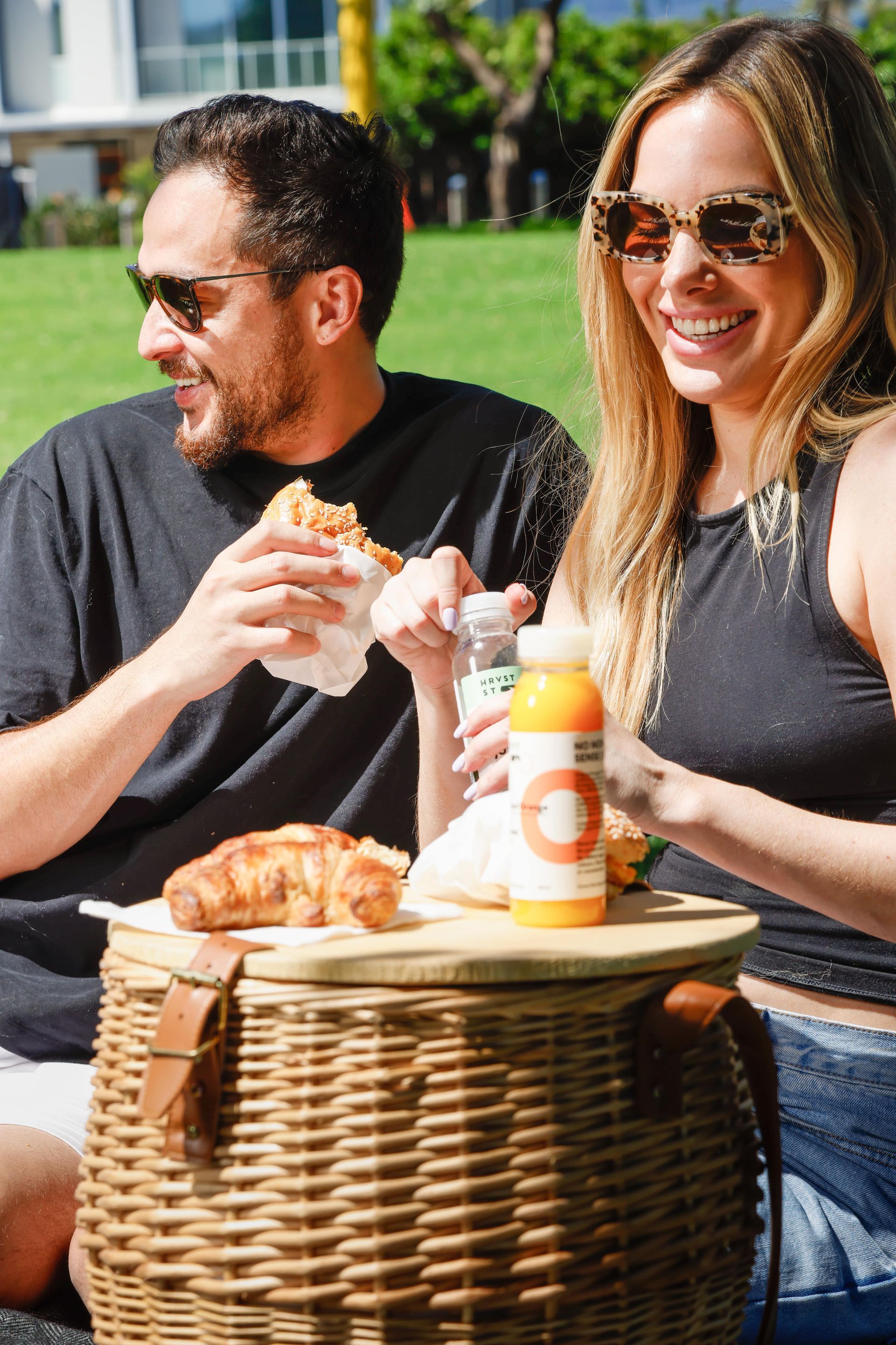 A man and a woman are having a picnic in a park.