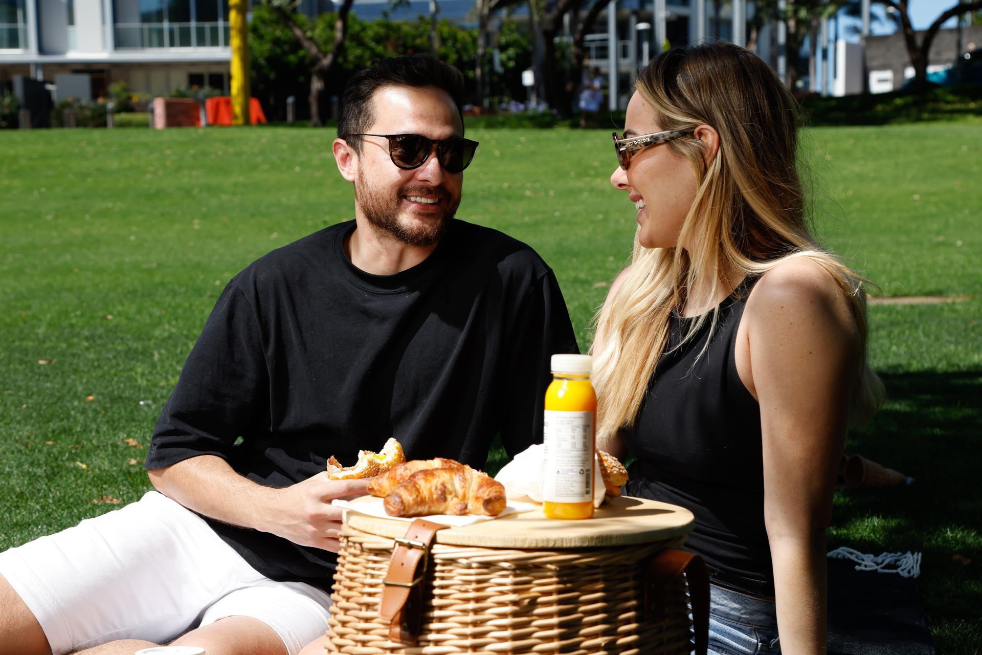 A man and a woman are having a picnic in a park.