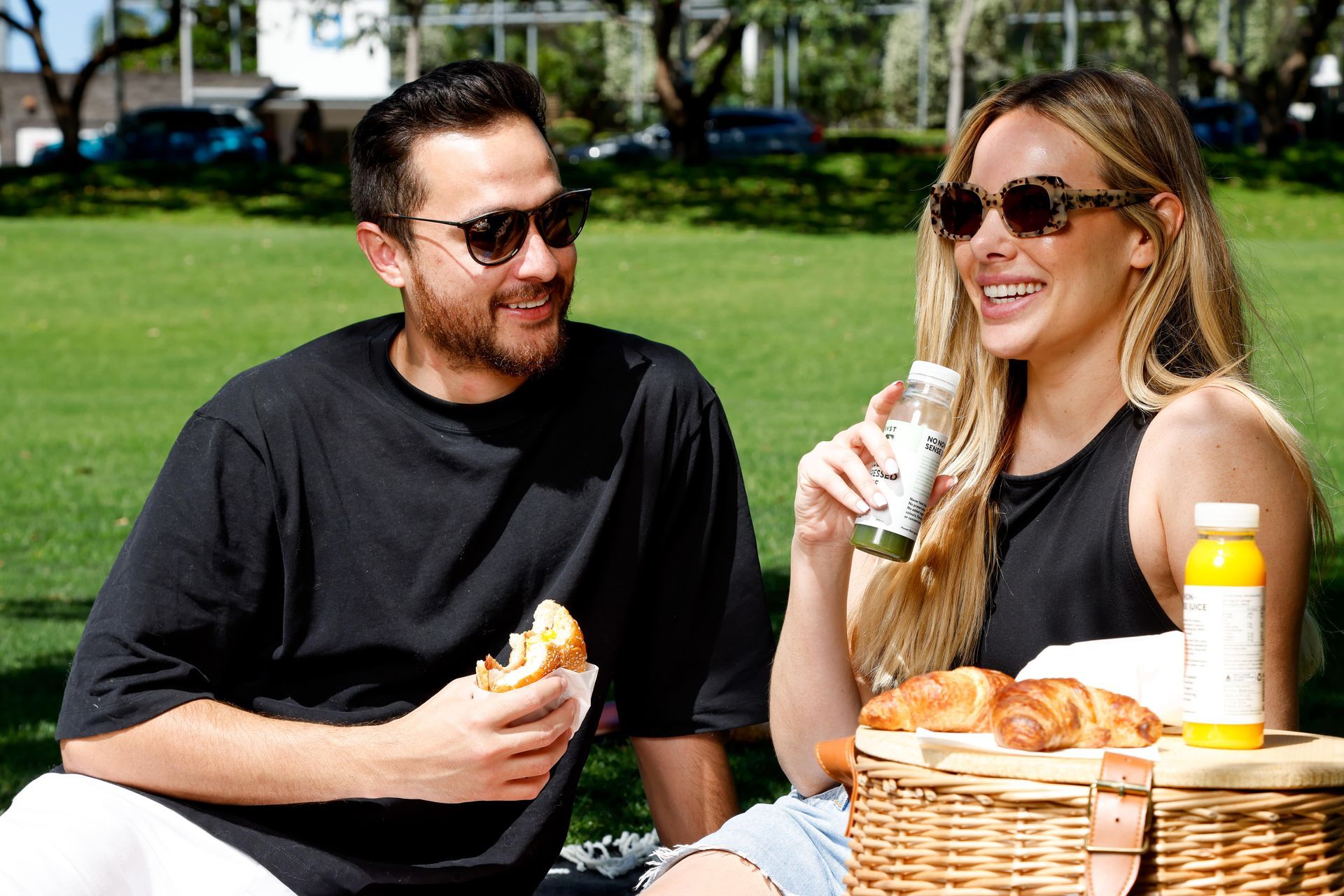 A man and a woman are having a picnic in the park.