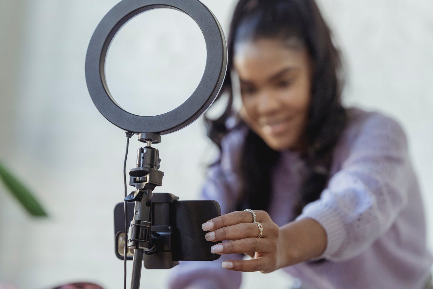 A woman is taking a picture of herself with a cell phone.
