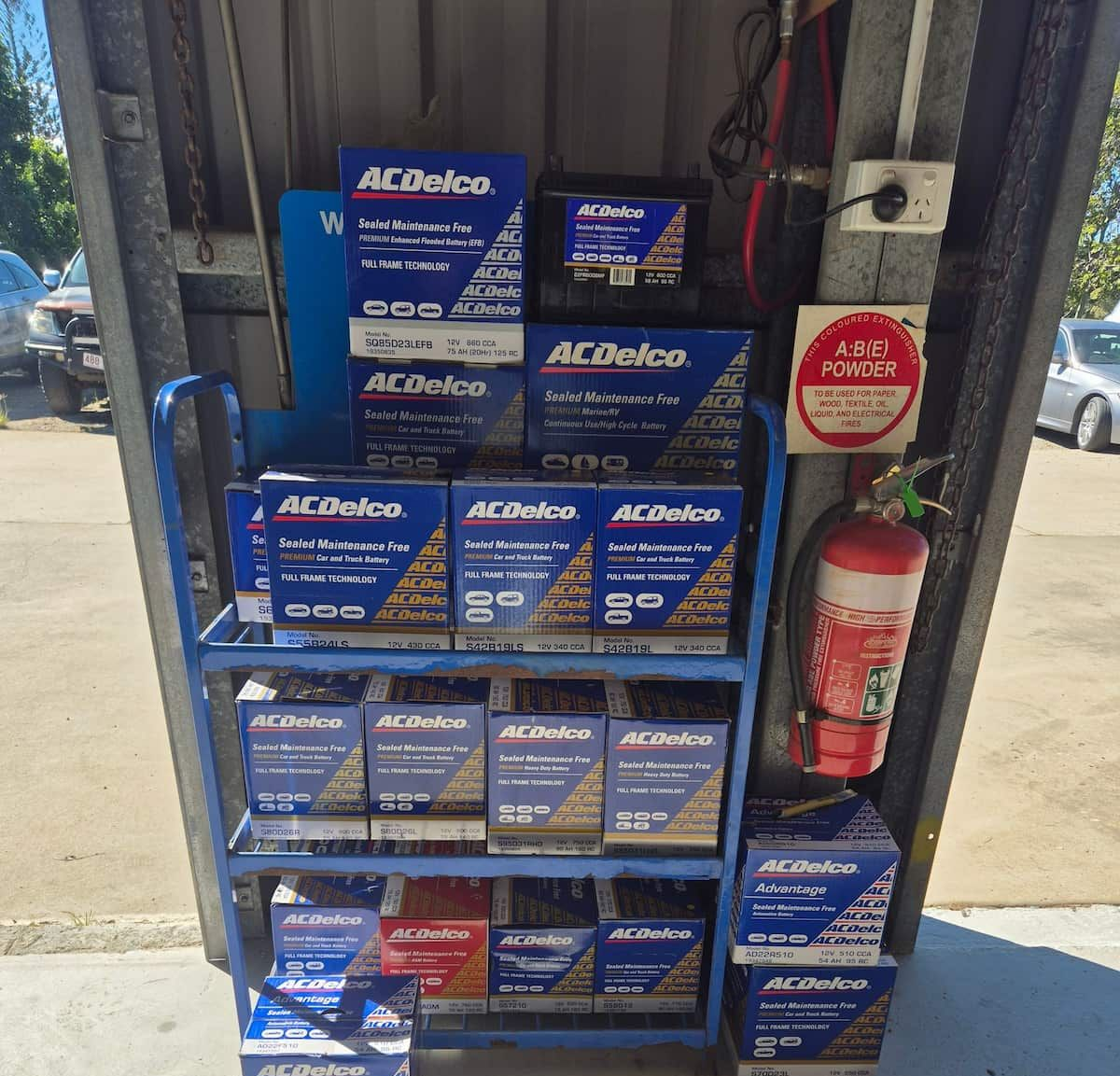Stack of blue ACDelco auto parts boxes on a shop display beside a fire extinguisher — Emu Park Automotive and Tyre Service in Emu Park, QLD