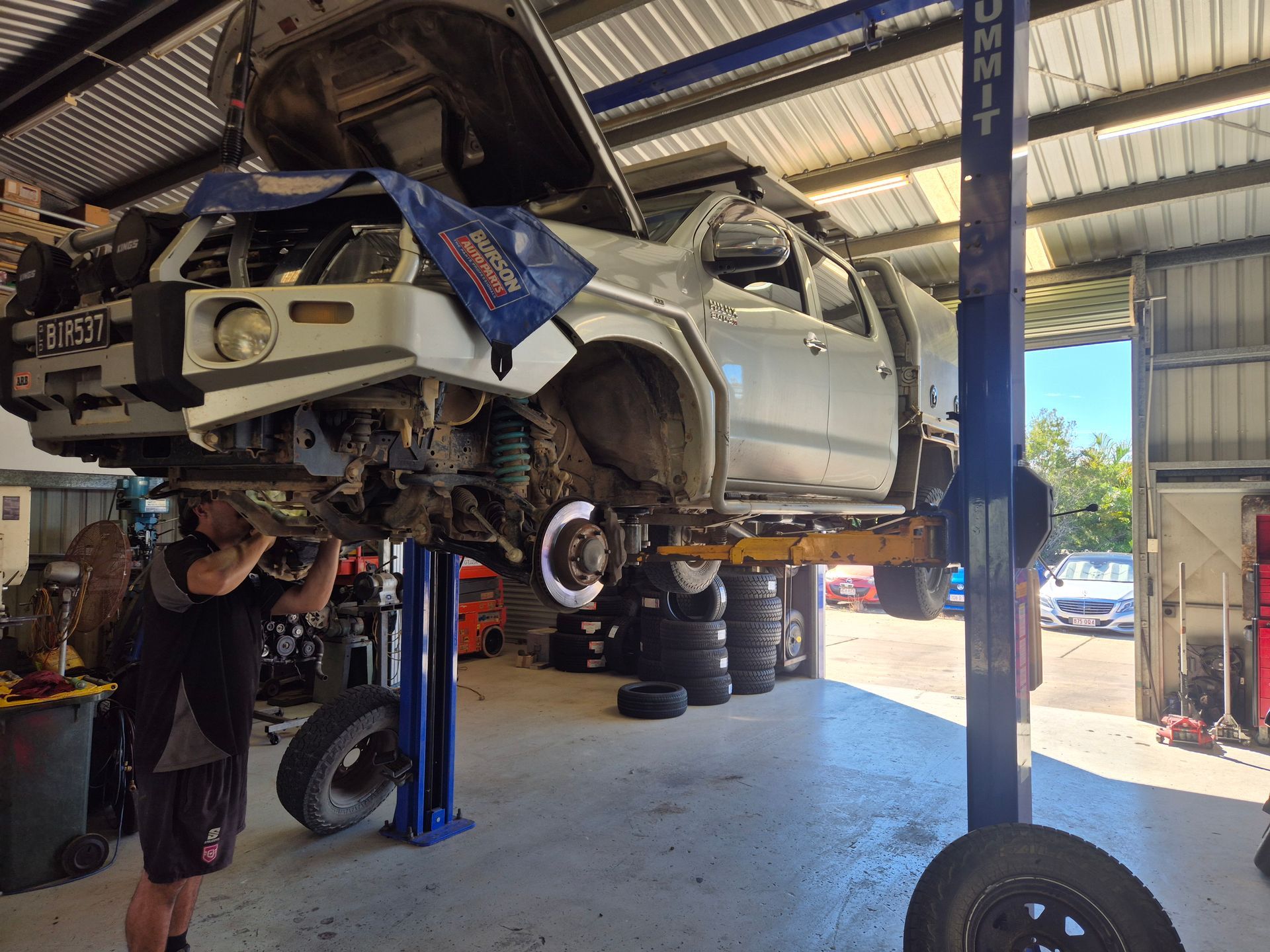 SUV Lifted in an Auto Shop, With Front-end Damage Being Repaired — Emu Park Automotive and Tyre Service in Emu Park, QLD