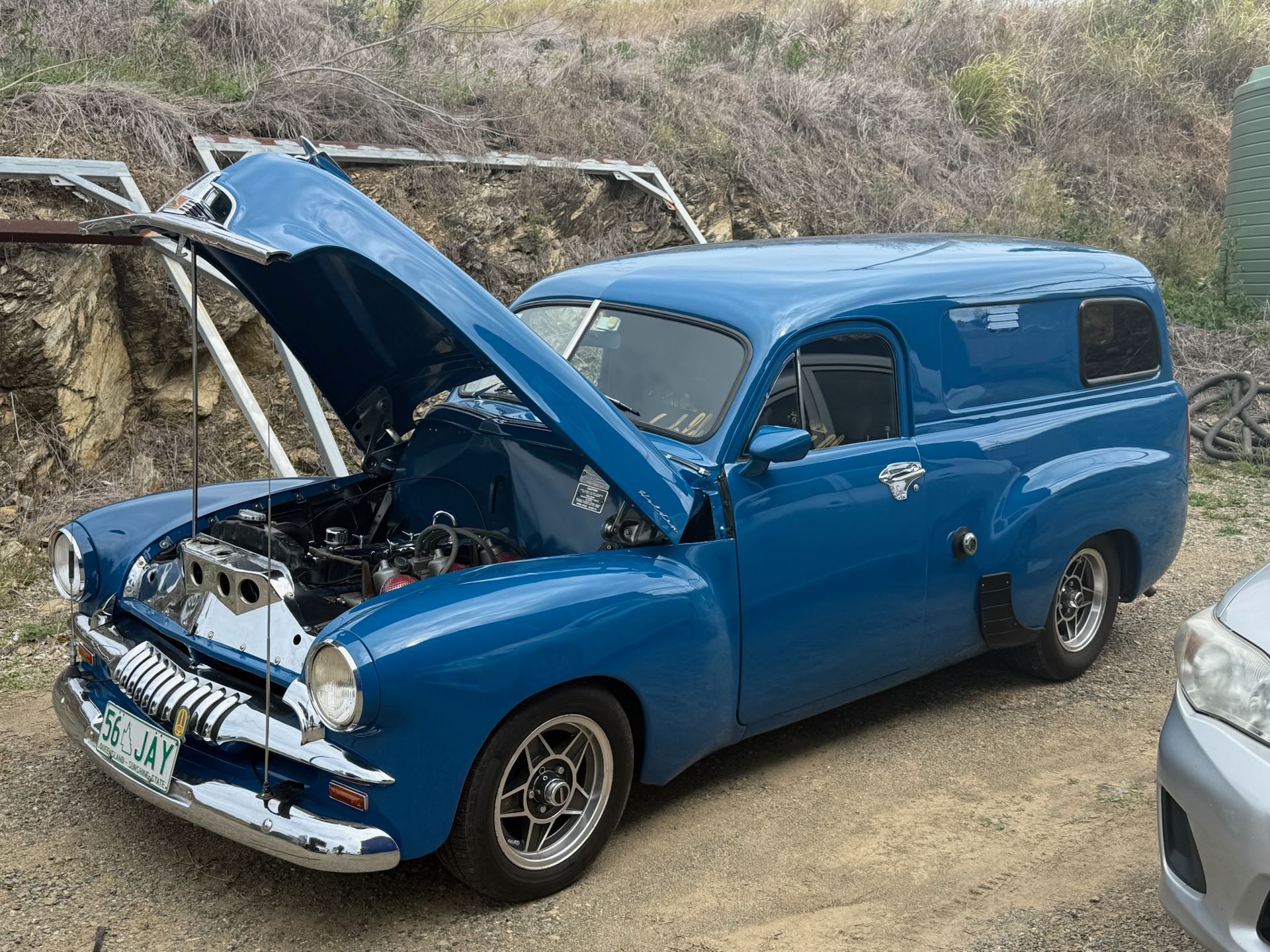 Blue vintage car with hood open at an outdoor roadside setting — Emu Park Automotive and Tyre Service in Emu Park, QLD
