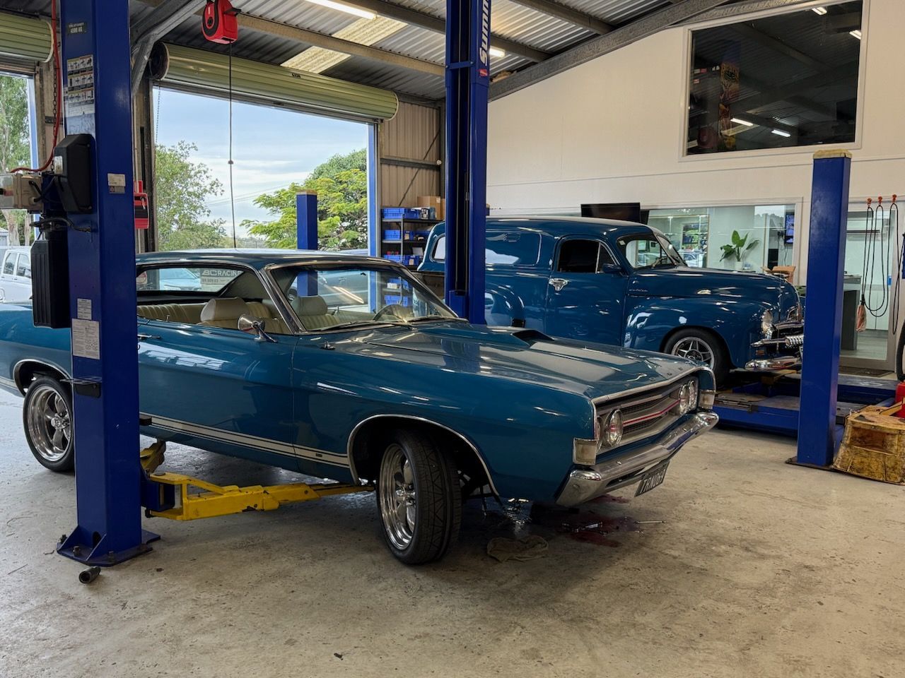 Blue Classic Car in an Auto Repair Shop Lift Bay — Emu Park Automotive and Tyre Service in Emu Park, QLD