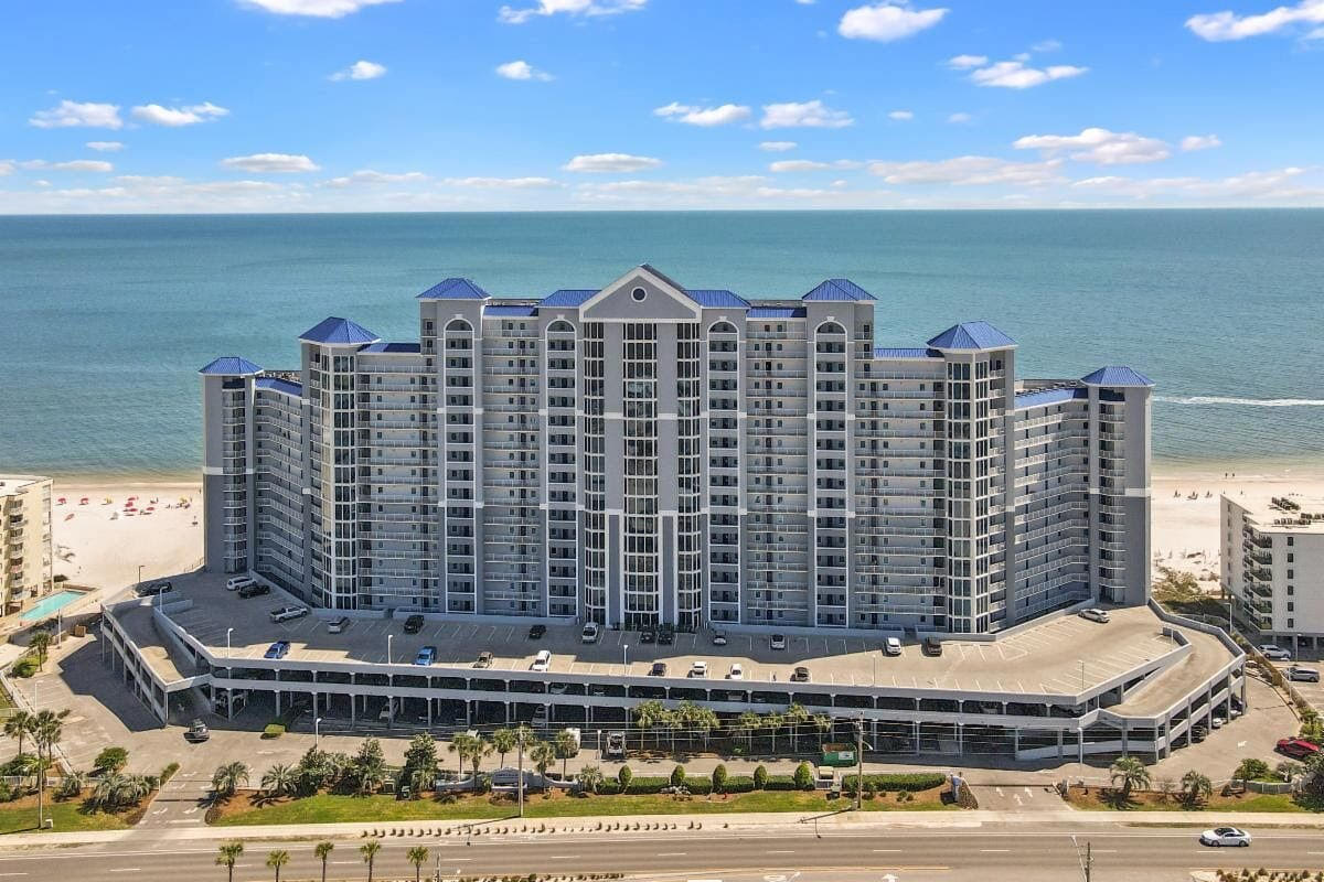 An aerial view of a large building next to the ocean.