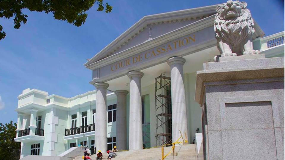 A large white building with a lion statue in front of it