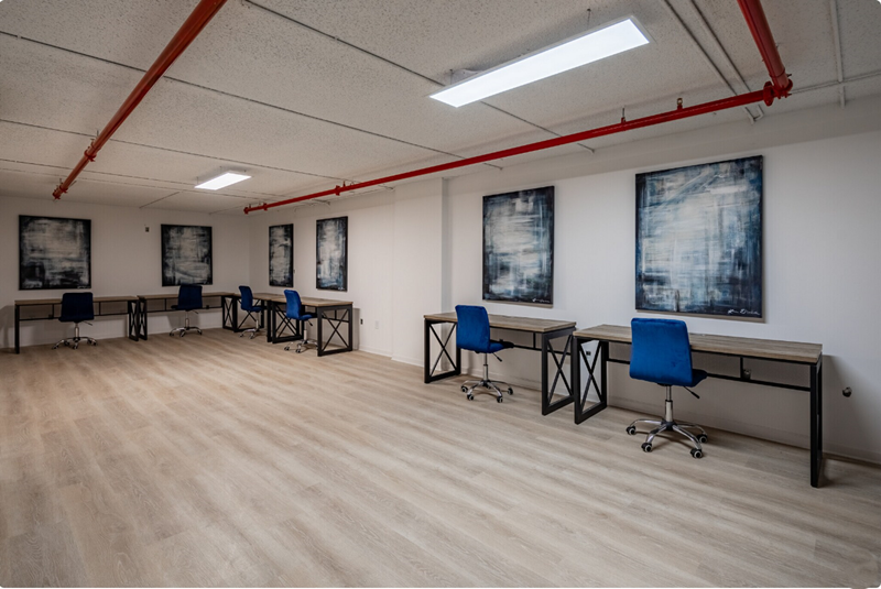 Photo showing desks and chairs occupying the perimiters of a room