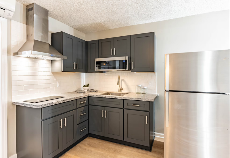 Photo showing a kitchen area with new, contemporary appliances