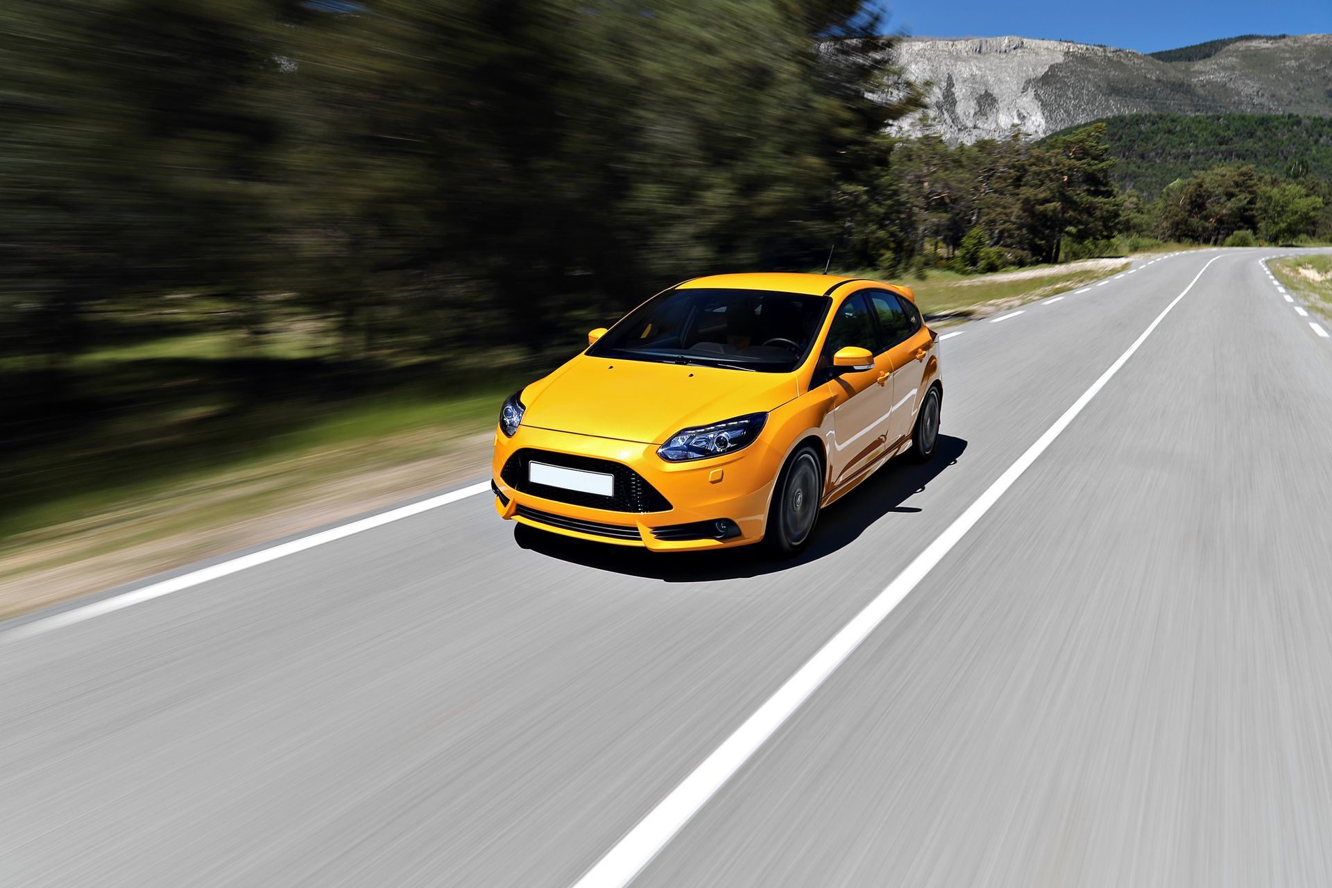 Yellow Car Driving on the Road - San Diego, CA - Independent Volvo, Saab, Jeep & Subaru
