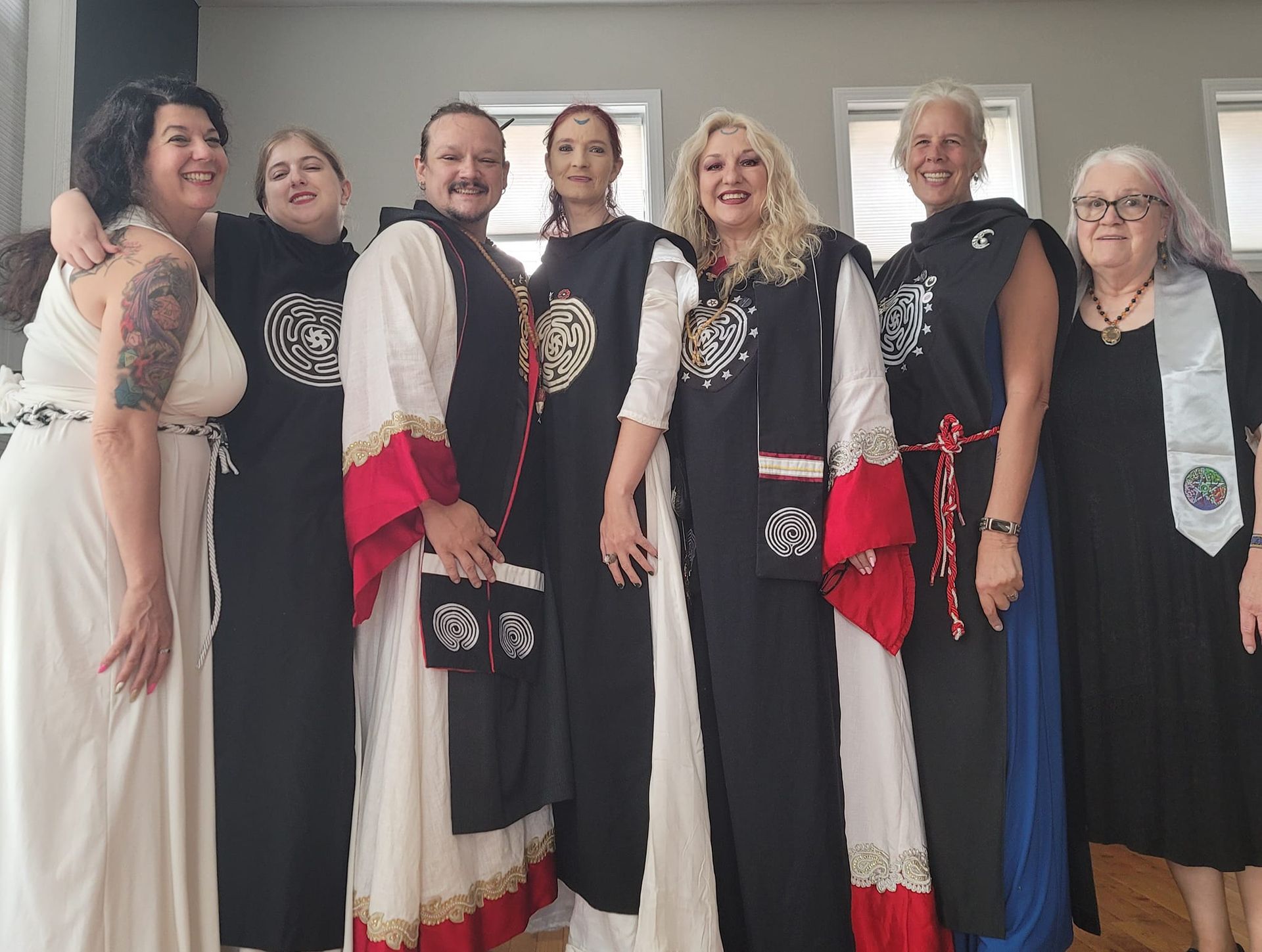 A group of women are posing for a picture together, members of the Aquarian Tabernacle Church.