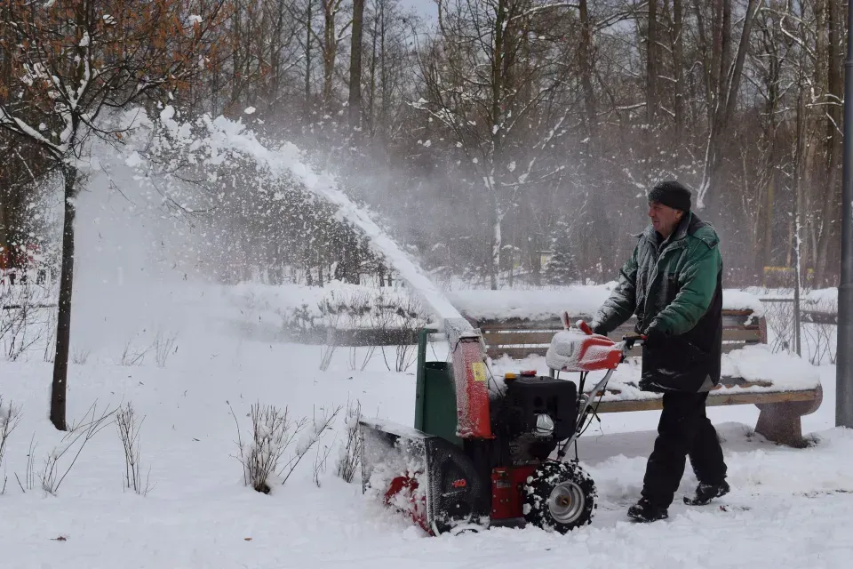 Snow blower clearing a path after a heavy snowfall