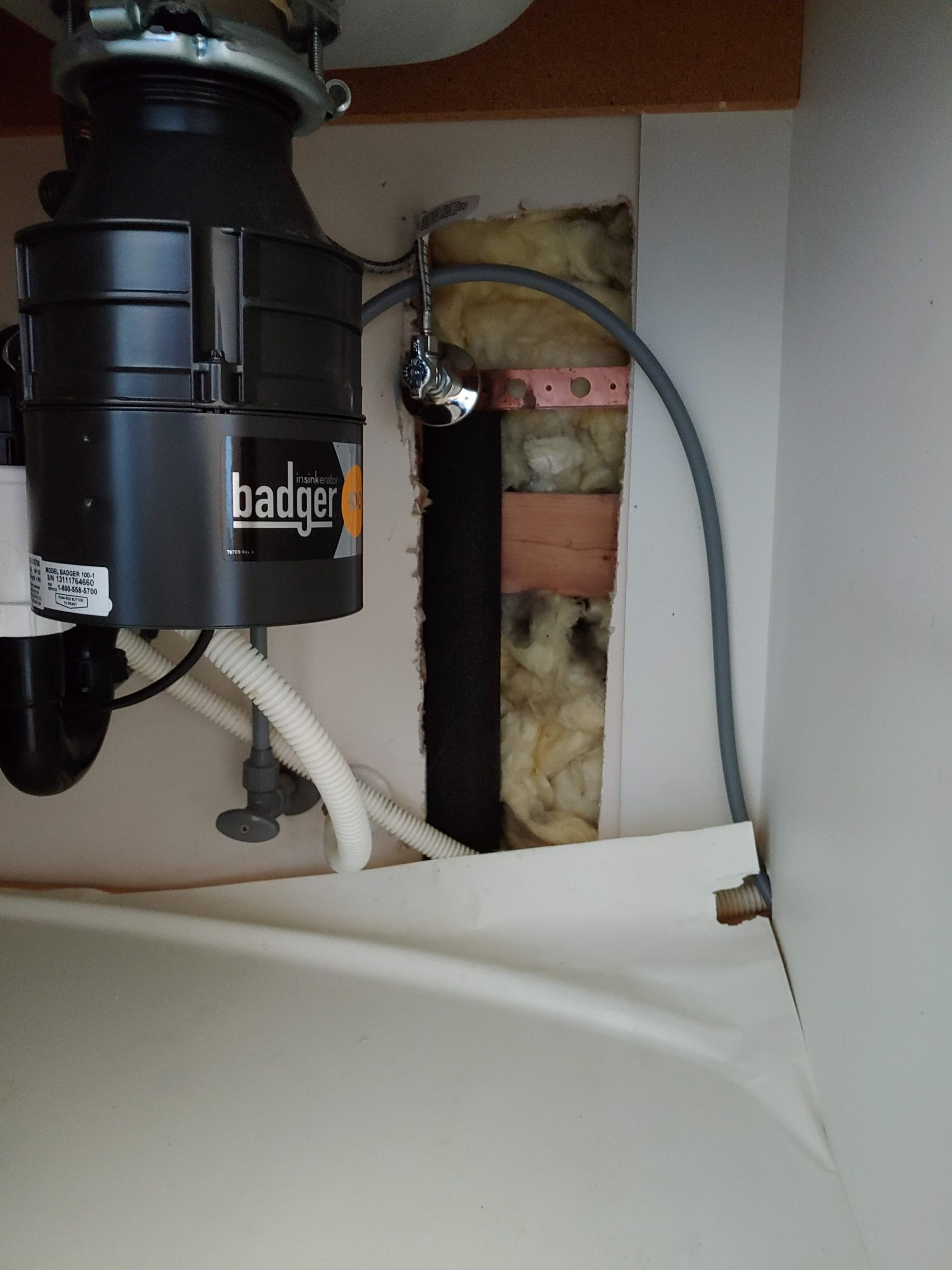 A badger garbage disposal is under a sink