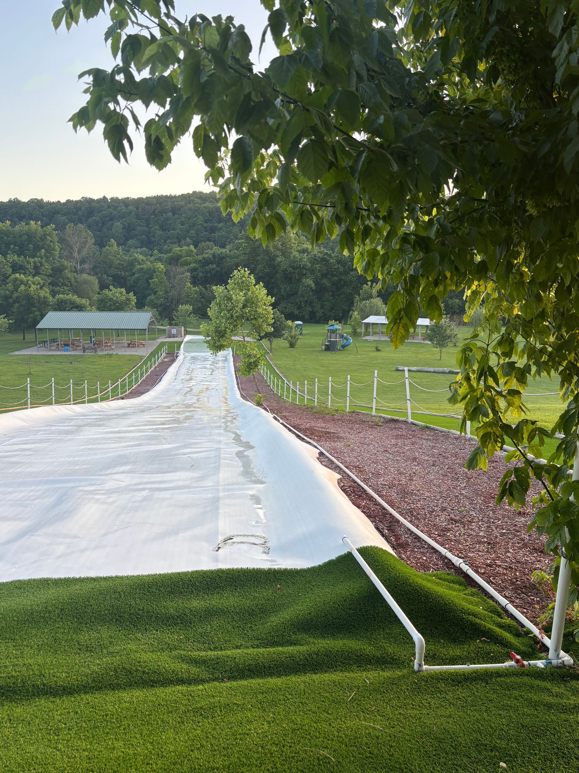 A group of people are riding down a water slide.