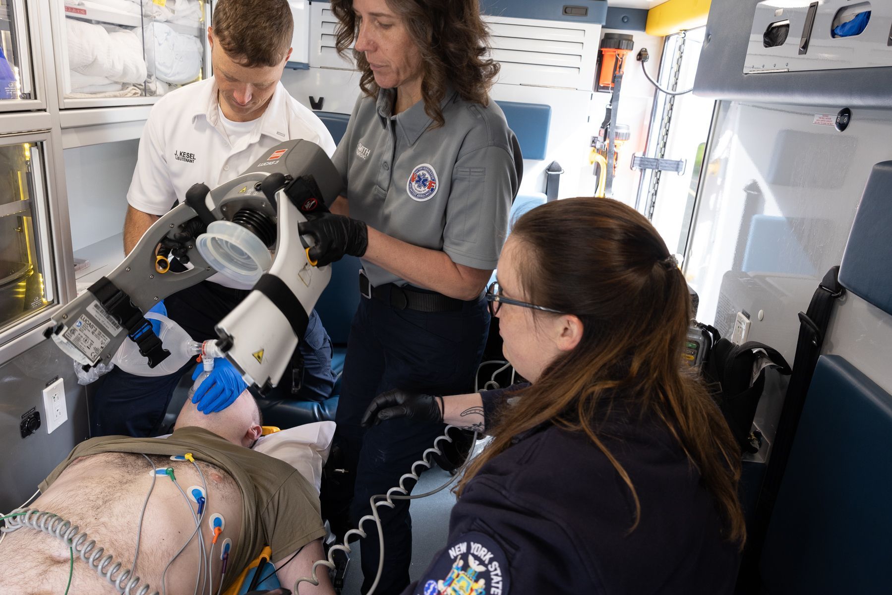 A Victor Farmington Ambulance crew works together caring for a patient (training scenario)