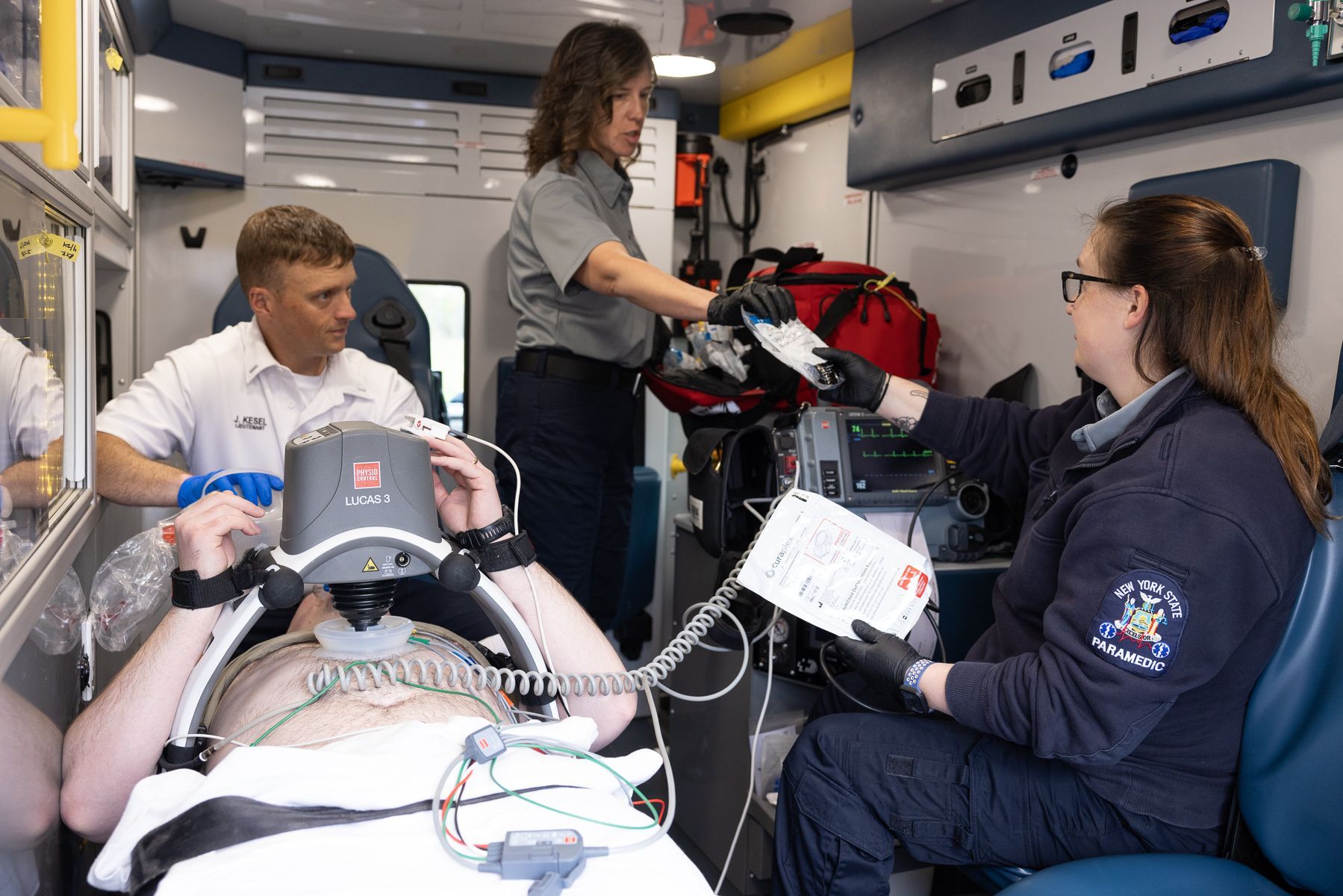 Victor Farmington Ambulance crew members provide care in the back of the ambulance (training scenario)