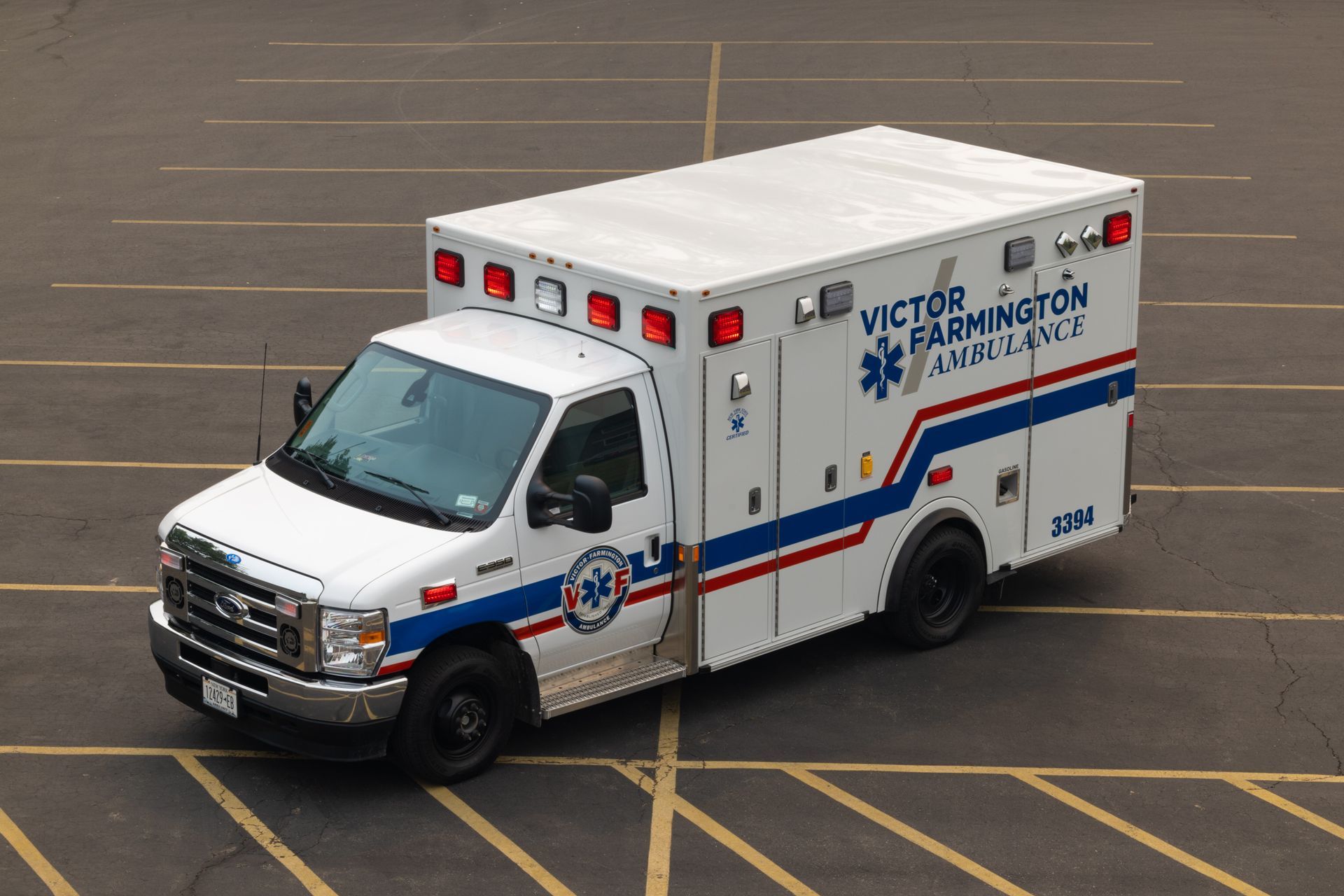White ambulance parked in a lot, marked “UCFD BOSTON.”