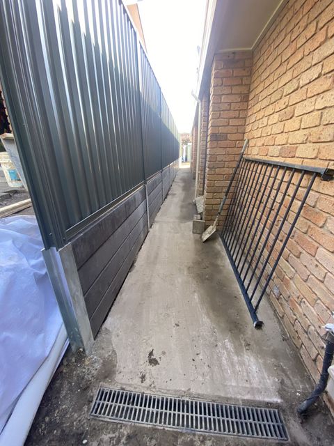Narrow Alleyway Between a Corrugated Metal Fence and a Brick Wall — Concrete Sleepers NSW - Port Macquarie in Sancrox, NSW