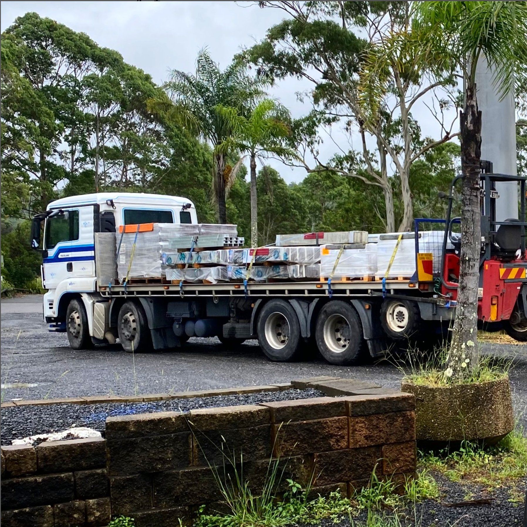 Flatbed Truck Loaded With Construction Materials — Concrete Sleepers NSW - Port Macquarie in Sancrox, NSW