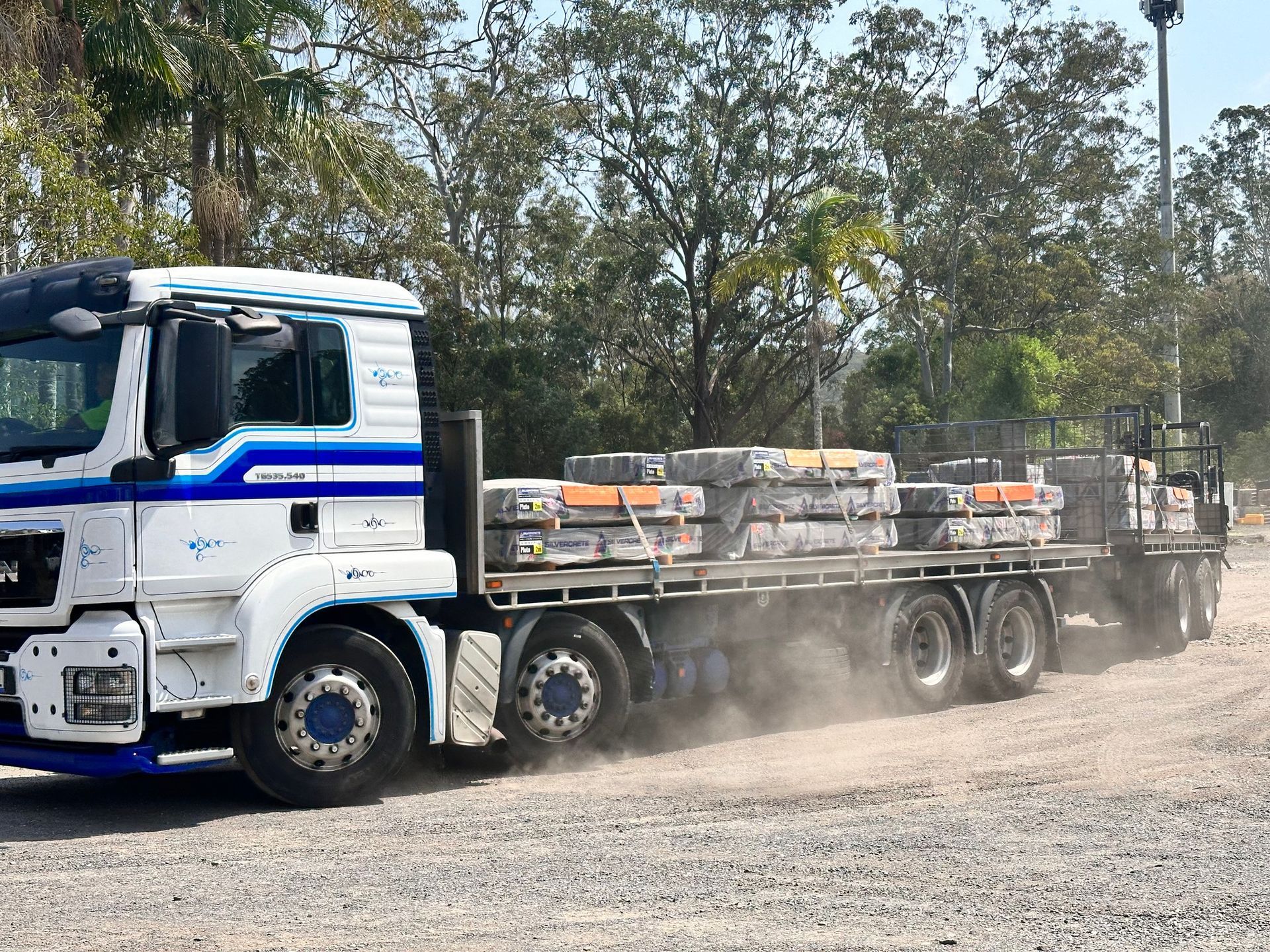 White Truck Hauling a Flatbed Loaded — Concrete Sleepers NSW - Port Macquarie in Sancrox, NSW