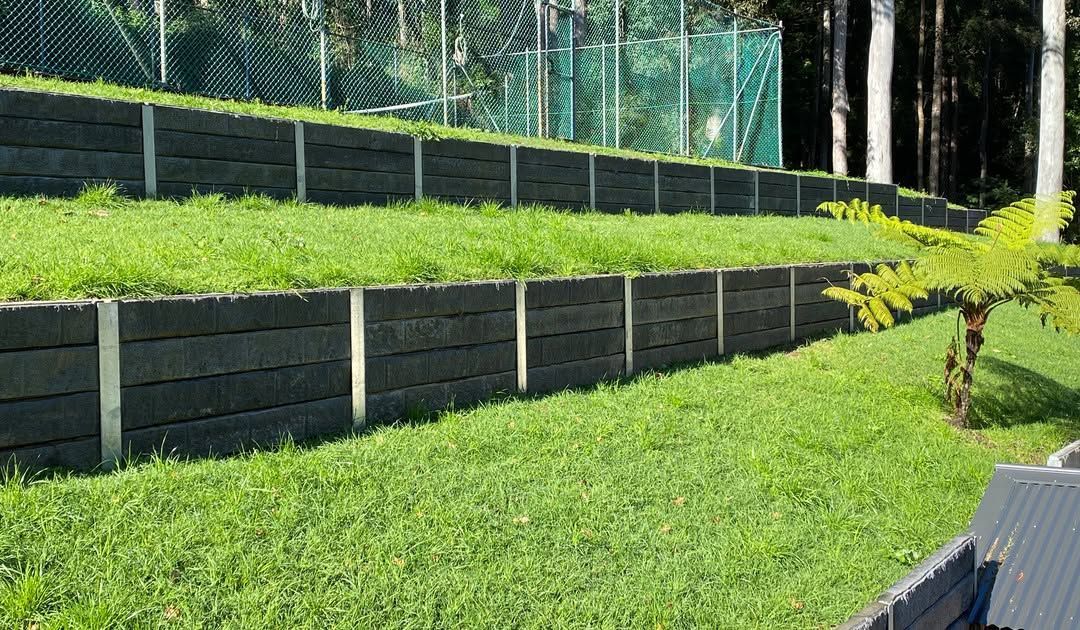 Terraced Grassy Hillside With Dark Retaining Walls — Concrete Sleepers NSW - Port Macquarie in Central Coast, NSW