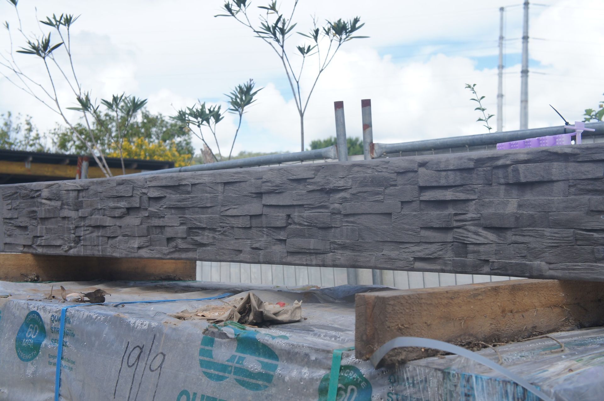 Construction Site With Gray Stacked Stone Wall, White and Brown — Concrete Sleepers NSW - Port Macquarie in Sancrox, NSW